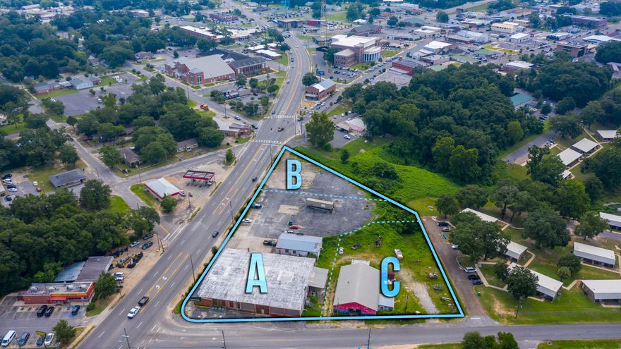 Three Buildings one block off of Main Street two blocks from Hwy 85 and 90 Intersection! Lots of Parking! Estimated 28K SqFt fro all three buildings. Main building was remodeled with Shabby Chic old and new mix! Brick walls wood ceilings glass store front windows! This would be a great lot for a new grocery, retail center or just move in for Restaurant, retail, multi-commercial lease! This has a Liquor store currently in operation. Previously this was a pawn shop with safe, office, gun room, storage and the back building was a tire store. Prime center of town location! Ask about the CRA district grant! Also have a smaller portion of this listing available.