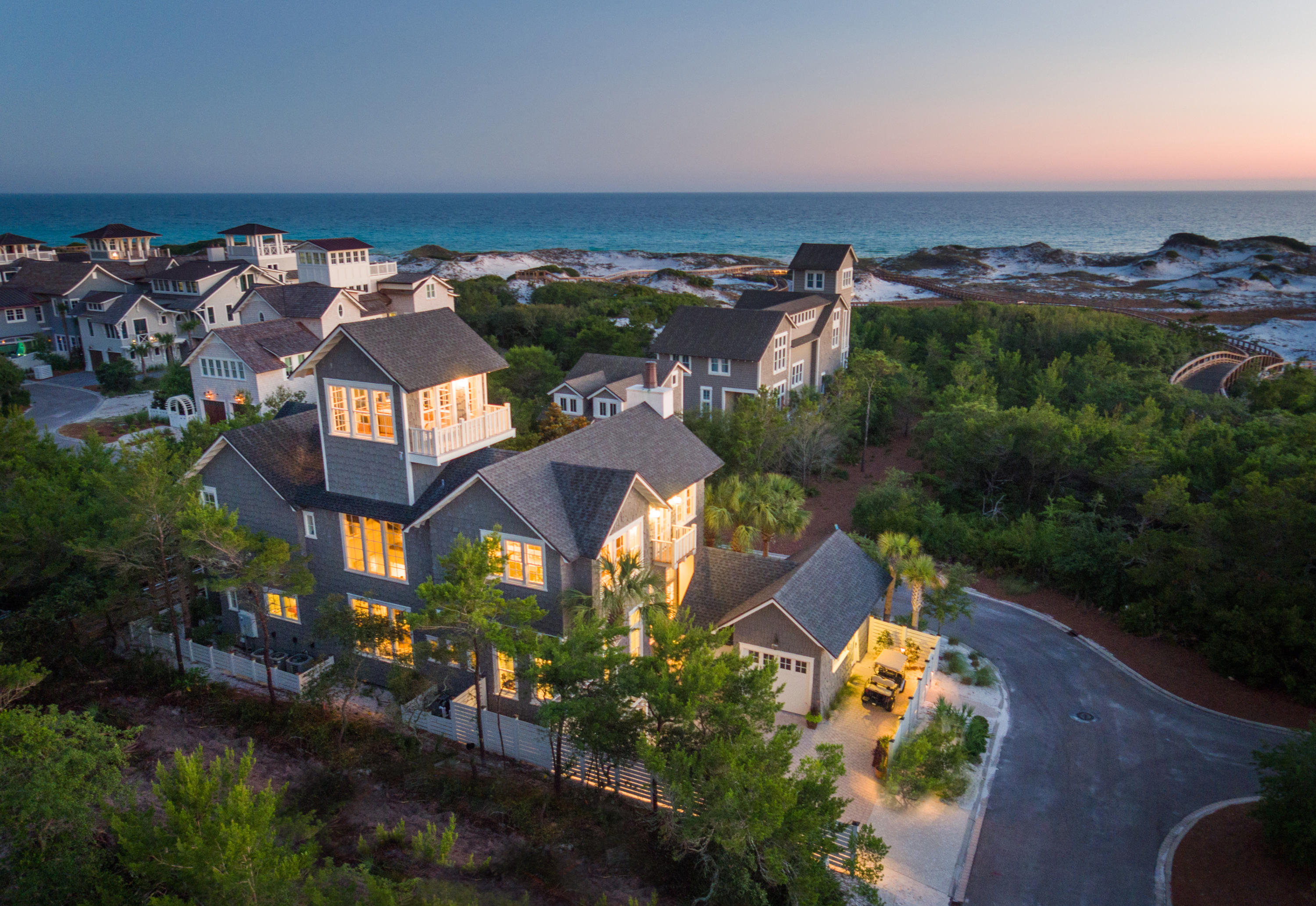 This custom residence in WaterSound Beach is sure to impress. Sitting only one homesite off the beach this home allows for unobstructed Gulf views which are amazing. Upon entering the courtyard one immediately appreciates the soothing sounds of the water feature. The outdoor area is complete with fire pit, summer kitchen, TV, powder bath & heated pool. This private retreat is the perfect spot for entertaining. The extraordinary use of skillful millwork & craftsmanship is evident in the custom trim, moldings, doors & cabinetry throughout the home. There is an abundance of natural light streaming through the plethora of windows on every floor. All of these upgrades set the tone for a gracious, relaxed ambience which is found throughout this one of a kind, unique & inspired beach home!