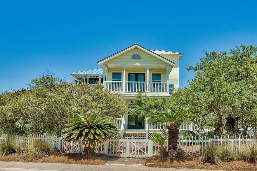 This charming four-bedroom, three-bath, beach cottage emits a plantation flair for its wide front porch and window shutters and sits just one lot in from the sugar white sandy beach. Live oak shade trees and a white picket fence frame the large corner lot. The open space living and dining space is flooded with natural daylight, and the kitchen pass-through is perfect for a buffet, breakfast bar or wine tasting. Enjoy gulf views from the second and third floor balconies. There are three private beach walkovers, a neighborhood community pool and clubhouse and a Draper Lake dock in this gated neighborhood. The opportunity here includes a great family vacation spot with rental options or a full-time residence for those who value location and the 2,757 square feet inside.