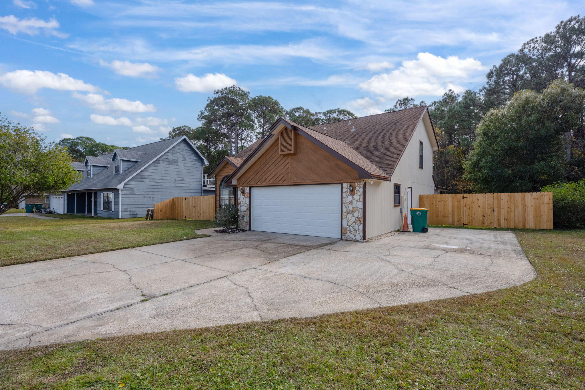 RV Pad / Pool home located in a hidden sidewalk community of Overbrook in the heart of Fort Walton Beach, this inviting home at 801 Overbrook Dr offers both privacy and convenience. Just 10 miles to Hurlburt Field, 12 miles to Eglin Air Force Base, and only 6 miles from the beaches on Okaloosa Island, it's ideal for those seeking easy access to work, shopping, and the beautiful Gulf Coast. Nearby major stores like Walmart, Sam's Club, and various grocery stores are just a few miles away, adding to the convenience. Step inside to a welcoming living room with a stone fireplace soaring through vaulted ceilings, setting a warm, open atmosphere. The open layout connects the living room, dining room, and kitchen, with a clear view from the breakfast bar to the dining area. The kitchen features a spacious island, granite countertops, and stainless steel appliances, making it perfect for both cooking and gathering. A recently renovated family/sun room (2024) leads to the Florida room and opens directly to the screened-in porch and inground gunite pool, an ideal setup for relaxation and entertaining.

On the main floor, you'll find a private master bedroom with an
ensuite bathroom that includes a travertine shower, double vanity, and walk-in closet. This level also features a full bathroom, a laundry room, and extra storage under the stairs. Real engineered maple wood floors and stairs add a warm, natural feel throughout the home.

Practical features make this home truly functional, including a whole-house central vacuum system, a wired alarm, and an intercom system connecting every room. Upstairs, a loft area and a Jack and Jill bathroom link the other bedrooms, each with walk-in closets, many cedar-lined. The air-conditioned walk-in attic offers massive storage with three access points, providing easy organization.

Outside, the backyard is complete with a newly installed fence (2024) for added privacy, an enclosed patio, a gazebo, a 2-car garage, and an extra pad for boat or RV storage. Hugger ceiling fans are installed throughout for extra comfort.

This Fort Walton Beach home balances style, functionality, and a central location, making it an exceptional place to live on the Emerald Coast. Perfect for those looking for a well-equipped, comfortable home close to the beach, military bases, and shopping essentials.