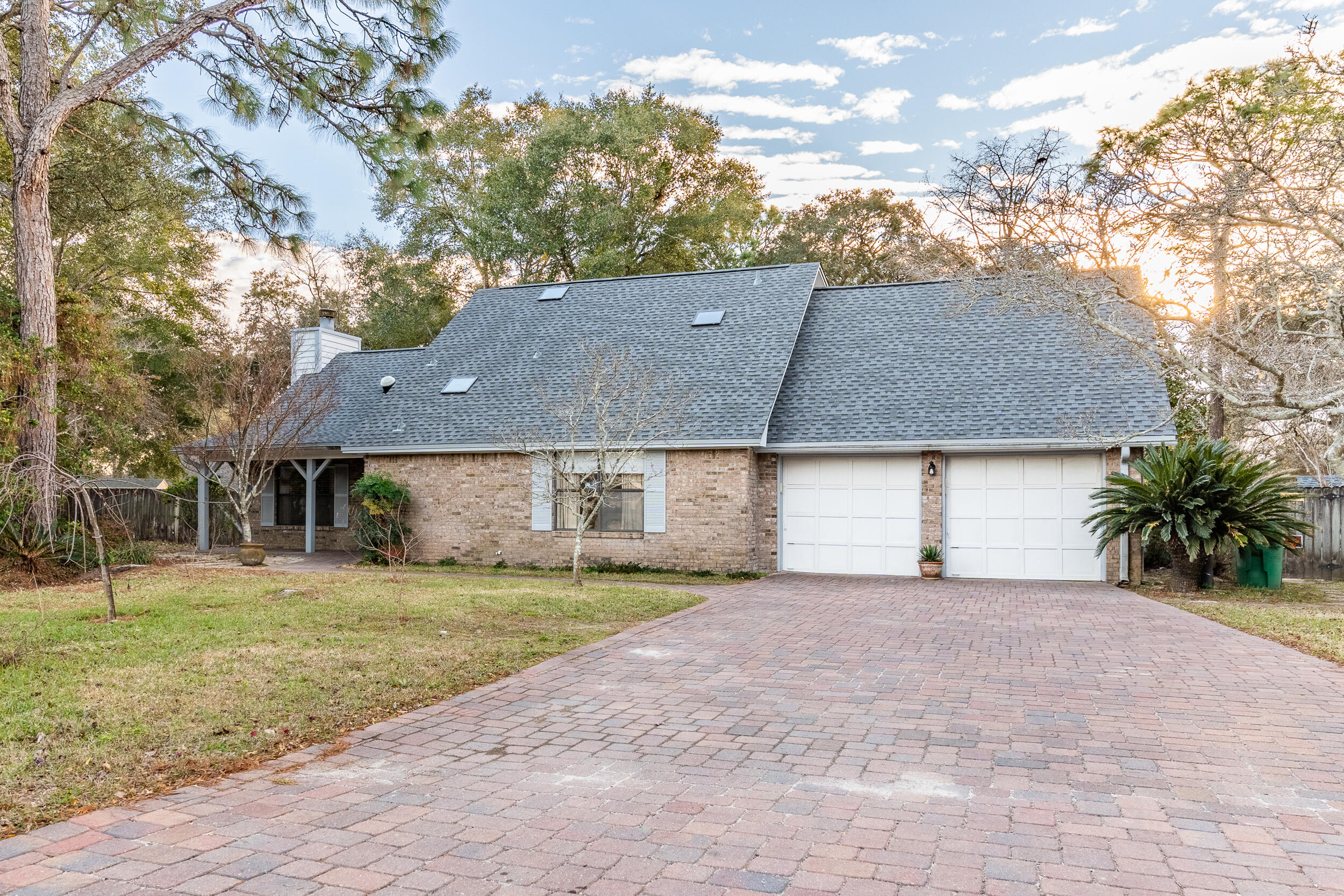 This beautifully maintained home in the Woodlands subdivision of Bluewater Bay is ready for its new owners. Upon entering the foyer, you are welcomed by a vaulted ceiling and the inviting warmth of a wood-burning fireplace. The dining room overlooks the living room and flows seamlessly into the kitchen, which boasts granite countertops, a double oven, and abundant natural light.The primary bedroom, located on the main floor, offers ample space for all your furnishings. The attached primary bathroom includes a tiled shower, and plenty of comfort. A convenient half bath on the main floor is perfect for guests.Upstairs, you'll find three additional bedrooms and a full bathroom. Recent updates include a new roof installed in November 2024, an HVAC system replaced in 2017, and a water heater updated in 2014. For added peace of mind, the home is protected by a Sentricon termite system, with a transferrable bond, and the seller is including a home warranty with ARW.

The backyard is a spacious retreat, fully fenced and ideal for nature lovers. It features numerous Japanese maple trees, a weeping cherry tree, and Japanese magnolias, creating a serene outdoor oasis. Relax under the covered patio while enjoying the view, and rely on the sprinkler system to keep the landscaping lush and vibrant.

This home offers a perfect blend of comfort, functionality, and natural beauty schedule your showing today!