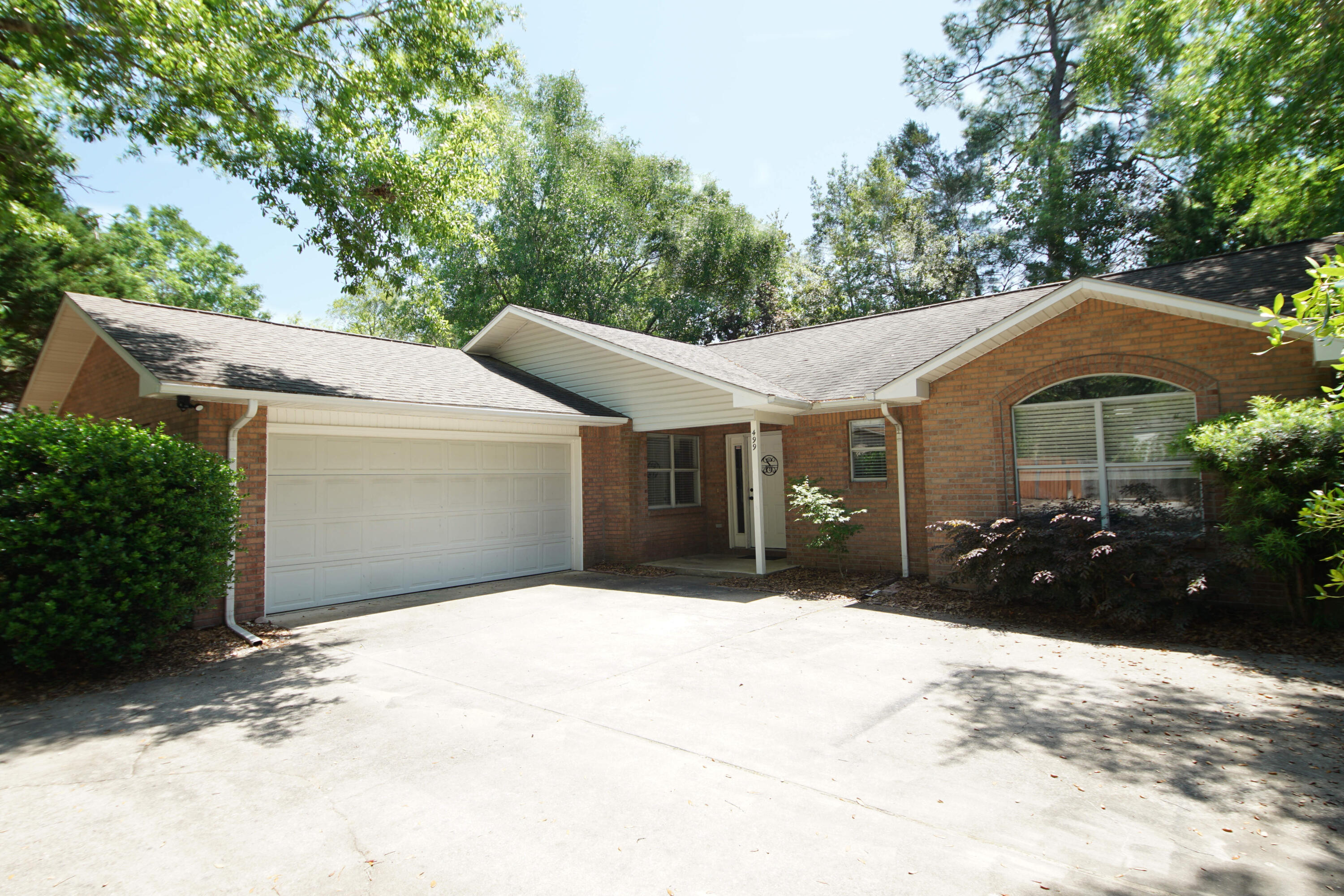 This charming 3 bedroom, 2 bathroom brick home offers a unique split floor plan, providing privacy and comfort for your family. The well maintained brick exterior adds durability and timeless appeal to this beautiful home. As you enter, you'll be greeted by a spacious living room with ample natural light, perfect for entertaining guests or relaxing with loved ones. The kitchen features brand new GE stainless steel appliances. The beautiful dolomite countertops provide ample counter space. The split floor plan ensures that the primary bedroom complete with an en-suite bathroom and walk in closet, is set apart from the other two bedrooms for maximum privacy . The additional bedrooms are generously sized and share a second full bathroom, making it perfect for family or friends. The property also includes a two-car garage and a driveway with ample parking space, and a relaxing screened in porch on the back. A new HVAC system was installed in 2023. All interior and exterior doors have brand new hinges and door knobs. They added a farm sink and a new disposal. All windows have custom blinds. The sellers had the entire interior of the house including doors, trim and chair rails painted . All of the carpet was removed and new LVP flooring was installed. The kitchen cabinets were painted a beautiful deep blue and new hardware was added. This is a beautiful, move in ready home .