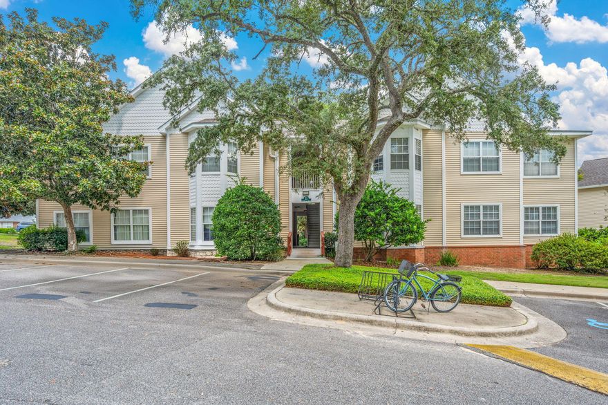 Welcome to this charming two-bedroom, two-bath condo located in the desirable Oaks community. Featuring an open and functional layout, this home offers a perfect blend of style and comfort. The interior boasts attractive wood-look laminate flooring, a bright bay window, and fresh paint throughout. The dedicated dining area flows into the kitchen, complete with stainless steel appliances, crisp white cabinetry, and ample natural light. A stylish tile entry and ceiling fans add both convenience and charm. The primary suite includes a walk-in closet and an en-suite bath with a bathtub/shower combo. The spacious guest bedroom has easy access to the second full bath, which features a large vanity and a walk-in shower. A stackable washer and dryer are included for your convenience. Outside, enjoy plenty of parking and access to community amenities, including a sparkling poolperfect for relaxing and socializing.