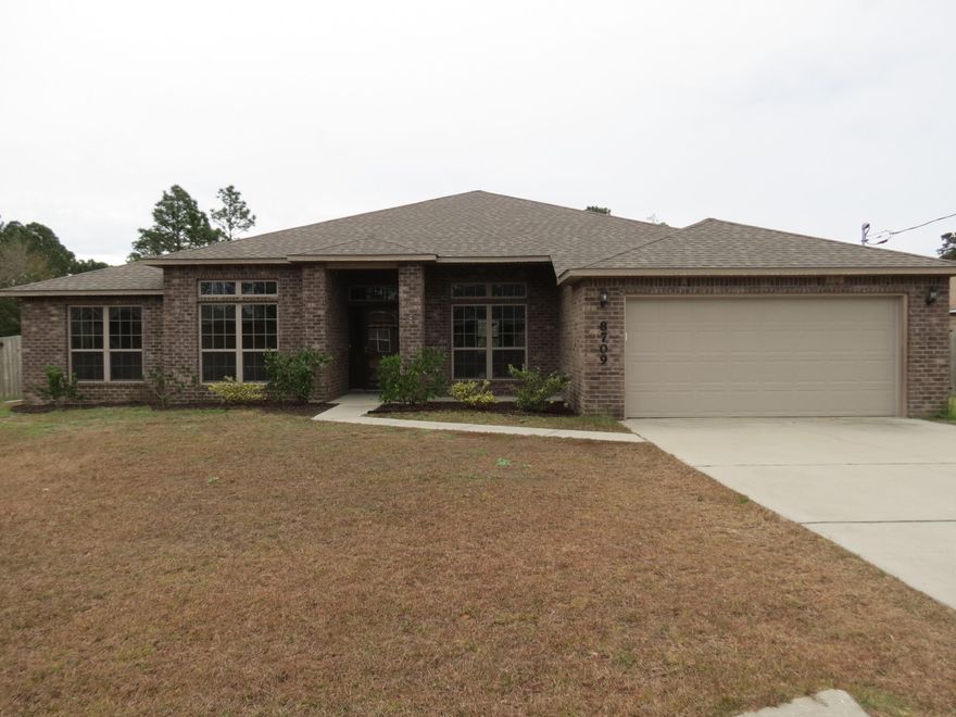 Move in ready! Beautiful all brick home located approximately 8 miles from the front gate at Hurlburt and 2 miles from Navarre Beach. This open floor plan features 4 bedrooms, 3 full baths with a split design, dining room, large family room, plus an Office with insulated walls for privacy. Kitchen has granite counters and an island with plenty of storage. Off the back of the home, you will find a covered porch with ceiling fan and large fenced in backyard with a fire pit. Double gates on one side with room to park a RV or boat. Home is wired for a home generator. Schedule your showing today!