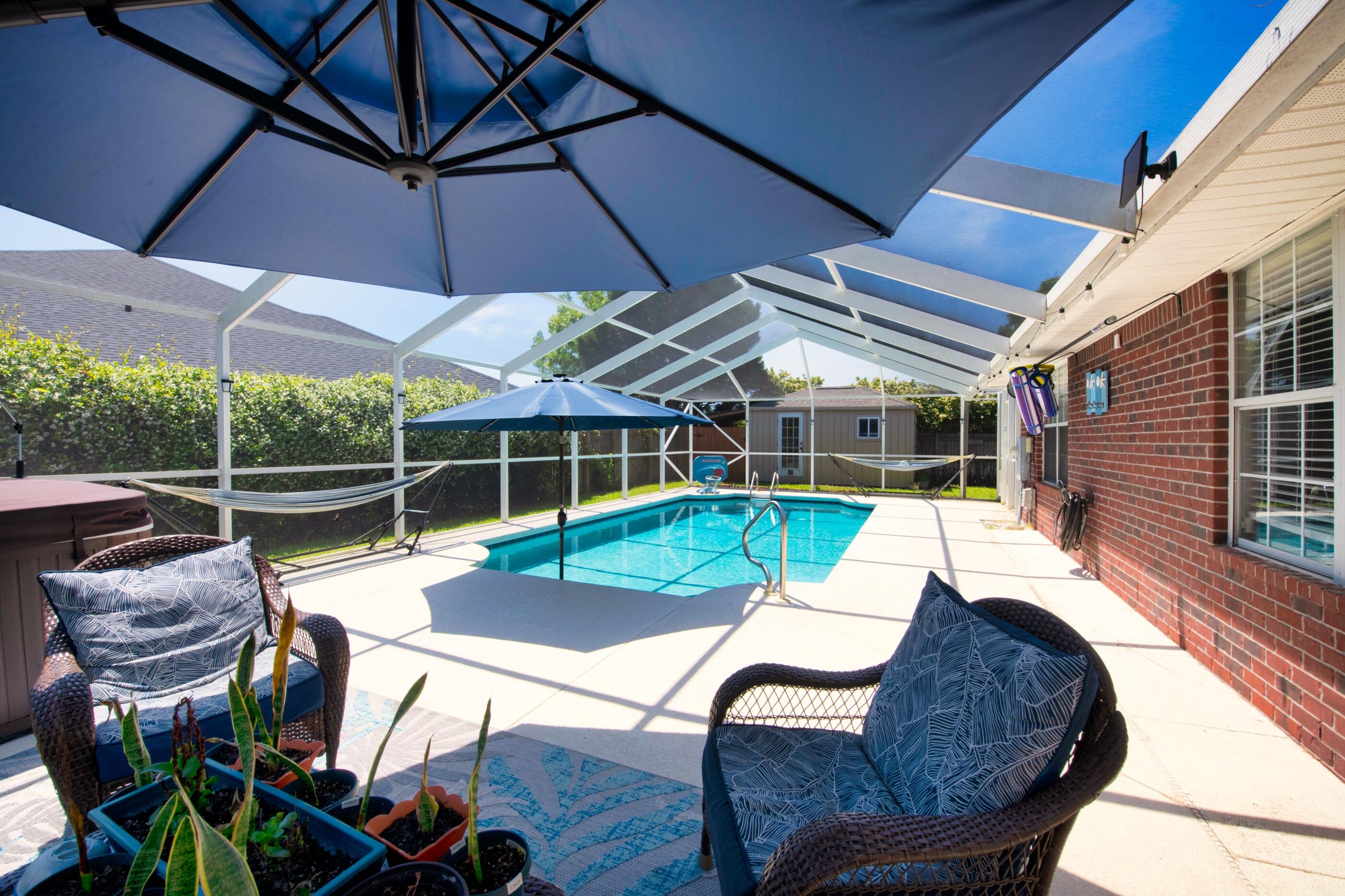 POOL HOME in East Navarre!!! Come see this beautiful 4 bedroom 2 bath home located close to the beach and Hurlburt Field. Featuring an updated kitchen with granite countertops and stainless steel appliances. This home is located on a corner lot and has a side entry expanded driveway with plenty of room for a boat or RV. The large backyard provides plenty of privacy to enjoy the enclosed salt water pool and hot tub. Additional features include an outdoor workshop, updated bathrooms, large laundry room, night light outlets, roof 11/2018, hot water heater 4/2019, salt water system 9/2018, kitchen appliances/granite countertops 2019, driveway expanded 3/2019, workshop 11/2018, remodeled master bath 2019, driveway expanded 3/2019, new HVAC 3/2020, garage floor tiles 2018.