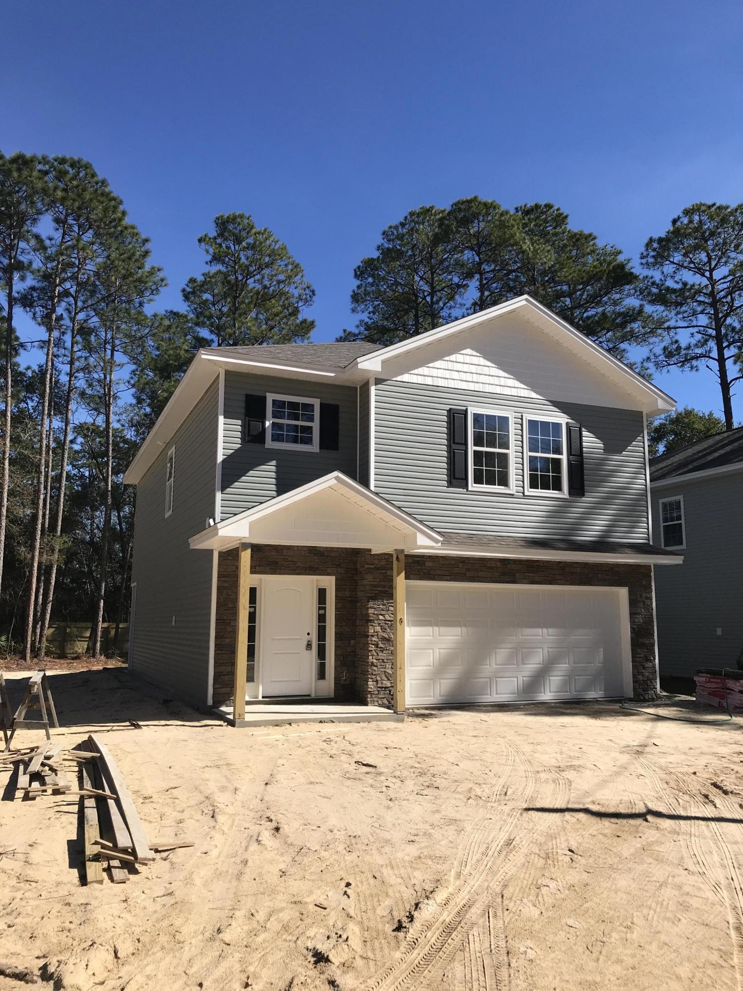 New Construction minutes from Eglin AFB! This spacious home will boast Quartz countertops, double vanities in both bathrooms, garden tub in the master bath, Luxury Vinyl Plank flooring and a large covered back porch! You'll love the kitchen features which include soft close doors and drawers, stainless appliances, open floor plan and white cabinets! The yard will be fenced with a sprinkler system included. This house is move in ready!