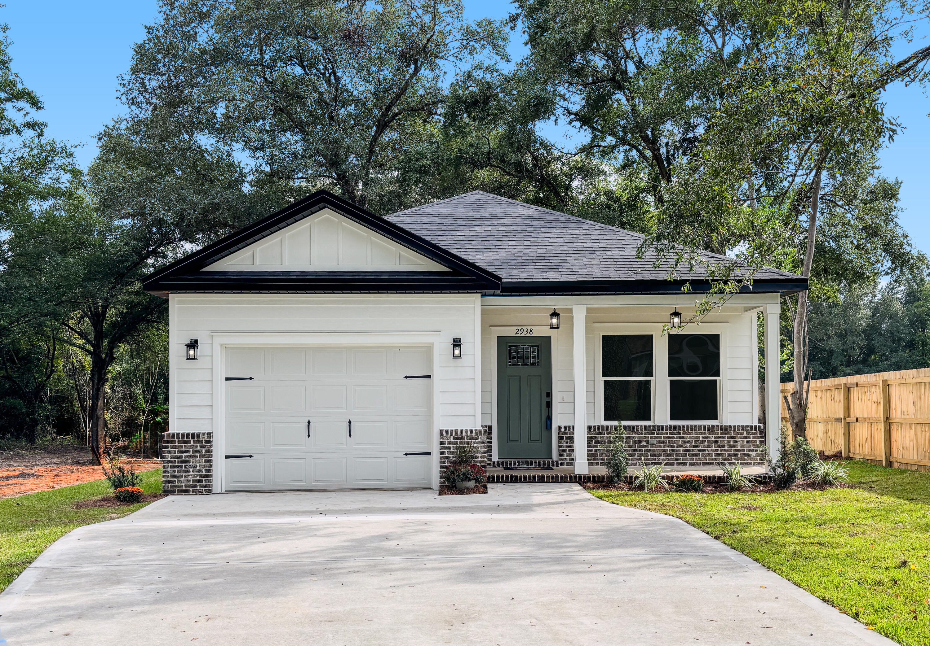 Enjoy the pleasures of new construction with this new 2024 built home on 0.38 acres in Crestview, complete with no city taxes! After pulling up the spacious driveway, take a minute to enjoy the views from the charming front porch with Hardie plank lap siding and a well-crafted tongue and groove pine ceiling. As you step through the front door, you're greeted by an open-concept space that seamlessly combines the living room and kitchen area, featuring 9-foot high ceilings with foam roof insulation and elegant vinyl plank flooring running throughout. The kitchen maximizes storage with custom-built cabinets and a breakfast bar, paired with glittering quartzite countertops and stainless steel appliances. Off the kitchen, a vestibule connects the laundry room and entry to a one-car garage, with a custom mudroom bench for organization. Down the hall, on the left you'll find a hall closet and a bathroom shared by generously sized bedrooms 1 and 2 on the right-hand side. At the back of the house, the spacious master bedroom attaches to an ensuite with abundant storage, featuring double vanities with quartzite countertops, a linen closet, and a walk-in closet. Out the back door is the covered porch overlooking a large expanse of yard for the puppy to play underneath the shade of large oak trees. This new home is situated the perfect distance from Crestview's best spots - less than 5 minutes to Azteca, Old Spanish Trail Park, Twin Hills Park, and The Marquis Cinema. Ready to see your new home? Schedule a showing today!