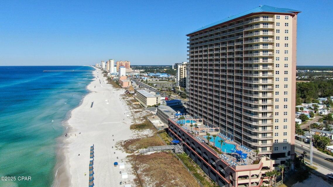Gulf-Front Condo with Breathtaking Views at Sunrise Beach. Welcome to your coastal escape at Sunrise Beach! This beautifully furnished 2-bedroom plus bunk room, 2-bath condo is perfectly positioned on a low floor for quick access and stunning, unobstructed views of the Gulf of Mexico, sugar-white sands, and unforgettable sunsets. Enjoy panoramic beach views from both the living room and primary suite, thanks to the impact-rated sliding glass doors that open to the spacious balcony. This condo is vacant and never used as a rental, making it exceptionally clean and ready to show at any time. Inside, you'll find granite countertops, high-quality tropical furnishings, full-size washer and dryer in a dedicated laundry room, and marble bathrooms, including a whirlpool tub in the master bath. Sunrise Beach Resort offers luxury amenities including: An elevated Gulf-front sundeck with two tropical pools (one seasonally heated), relaxing spas and a children's splash area, a Gulf-front fitness center, meeting room, and owner storage closet, and a covered parking garage conveniently located beneath the building. Situated directly on the beach and just minutes from Pier Park, Frank Brown Recreation Center, Pirates Voyage dinner show, and Top Golf, this condo is ideally located for both relaxation and recreation. Don't miss your chance to own a turnkey beachfront retreat with unbeatable views and first-class amenities. Schedule your private showing today!