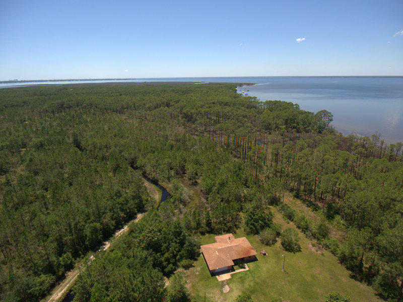 Wonderful location and INVESTMENT opportunity. 9.75 acres with a bay view, very close to all shopping and excitement the Emerald coast has to offer. Within a mile of boat ramps, public parks and yet a very peaceful dead end street and only 100 yards to the bay. The property is low and has some flood zone requirements. Seller has been informed that there can be new homes built here and most likely will required flood insurance and require new homes being elevated. All homes would have a great view of the bay.