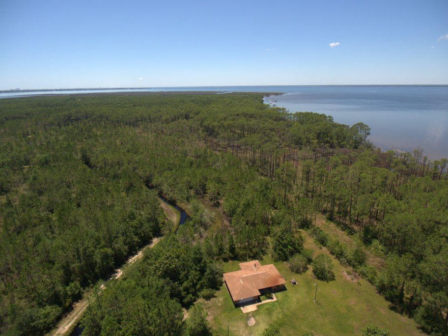 Wonderful location and INVESTMENT opportunity. 9.75 acres with a bay view, very close to all shopping and excitement the Emerald coast has to offer. Within a mile of boat ramps, public parks and yet a very peaceful dead end street and only 100 yards to the bay. The property is low and has some flood zone requirements. Seller has been informed that there can be new homes built here and most likely will required flood insurance and require new homes being elevated. All homes would have a great view of the bay.