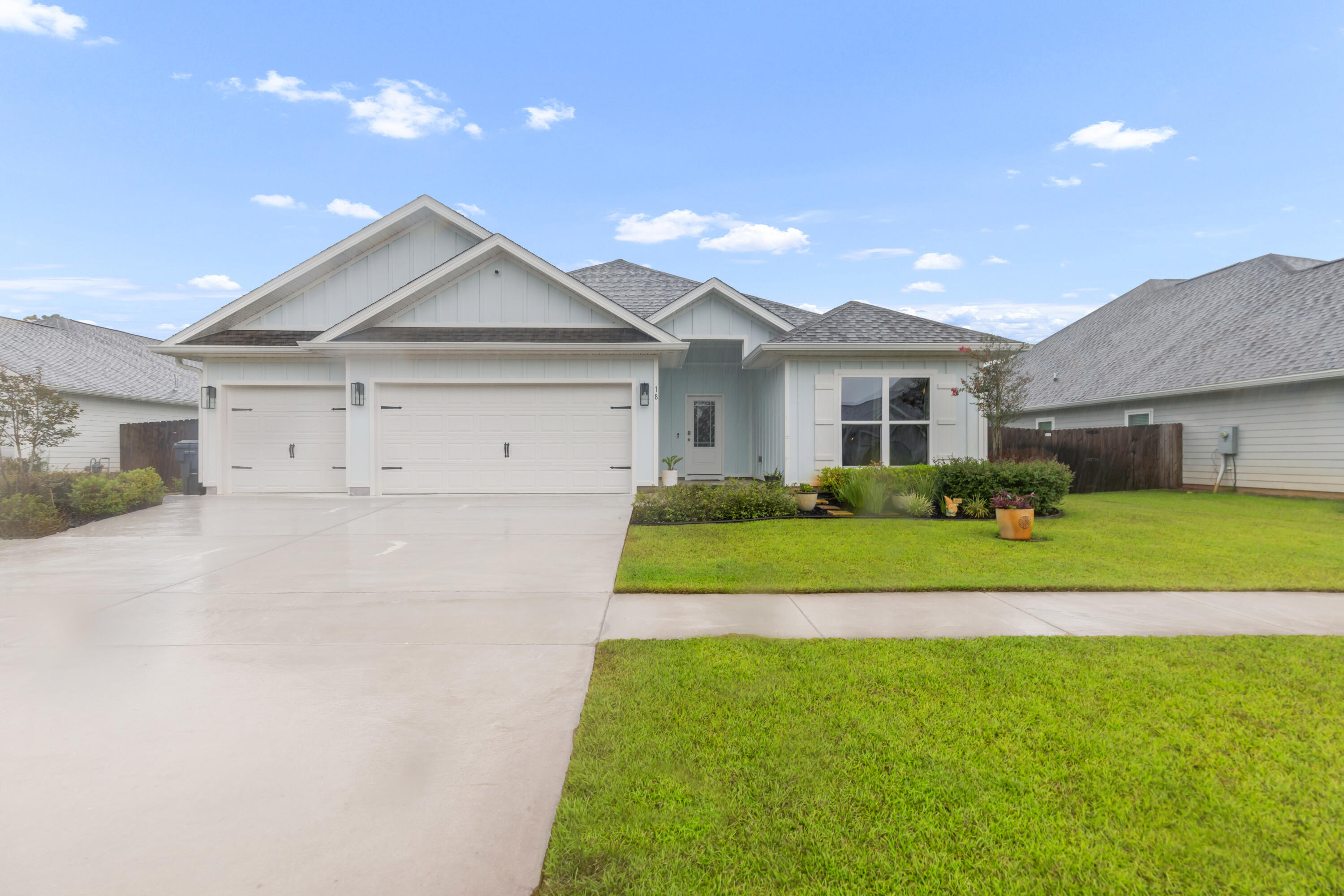 Welcome to 18 Hammock Circle in sunny Freeport, FL! This thoughtfully designed 4 BR, 3 BA home features a three car garage with large, level, fenced backyard on a beautiful pond in Hammock Oaks. You are greeted by an extra-wide foyer with shiplap accents and a convenient drop zone. The heart of the home is the living area which centers around a quality custom tile-surround fireplace and mantel. Living flows into kitchen complete with quartz countertops, ample cabinetry, generous corner pantry and stainless appliances. The primary suite offers his and hers walk-in closets and a luxurious bath with dual vanities, framed mirrors, soaking tub and separate shower. A large back patio is covered and screened with an additional open patio also. Additional concrete pad on side of home if shed i desired. Spacious laundry room, LVP flooring throughout, and lots of storage make this house both beautiful AND organized. The yard is irrigated and fully fenced with privacy fencing on sides and black aluminum fencing and gate on the back of the property to enjoy the water view. Plenty of room for a pool. Just 19 miles from the sugar-white sands of 30A where scenic beach towns, local boutiques and delicious dining await in places like Blue Mountain Beach, Seaside, Alys and Rosemary! Buyer to verify all dimensions and information important to them.