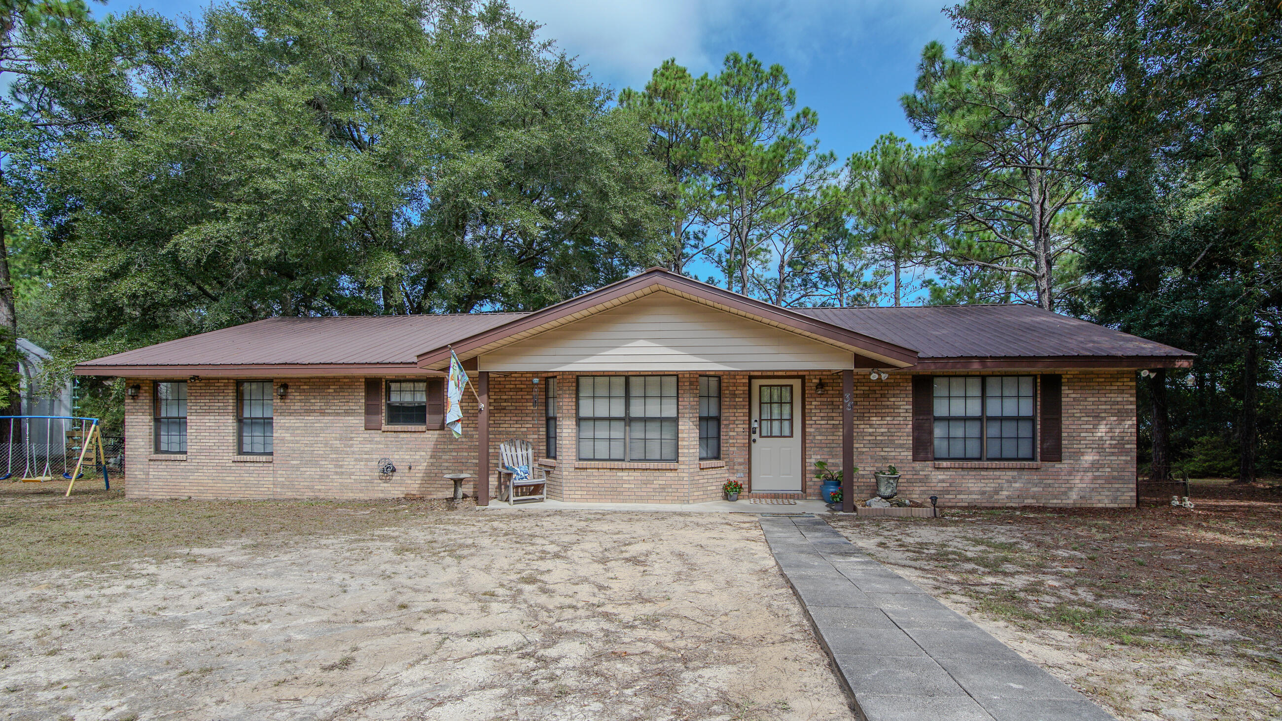 Charming and ready-to-enjoy 4 BR/2BA waterfront home on beautiful Juniper Lake. Enjoy peaceful lake views from your back deck or if that isn't enough, you are less than an hours drive to the beach. Inside, you'll find an open concept layout, updated flooring, and kitchen appliances that are less than three years old. Metal roof is 9 years old and hot water heater replaced in 2022. All four bedrooms are spacious, and there's a separate utility area for added convenience. Got hobbies or need extra storage? The detached garage/workshop has you covered. Sitting on .84 acres with a circular drive, this home's clean, move-in ready, and great for a big crew. Don't miss this rare lakefront gem!