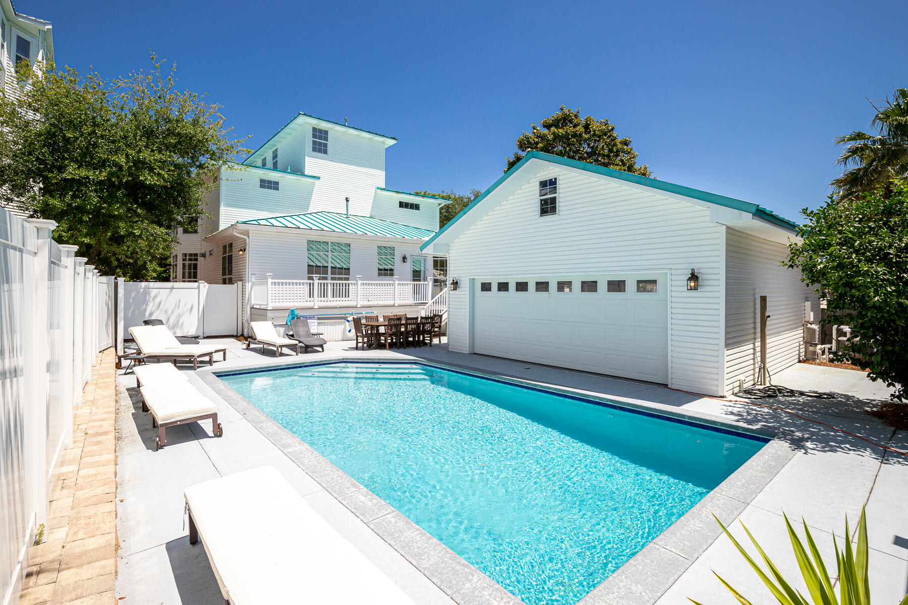 Nestled at the end of a tree-lined cul de sac and behind a white picket fence, this 5 bed/4.5 bath beach house has an expansive outdoor space with a private heated pool and huge game room that can double as a bunkroom. With barely a 5 min walk from deeded beach access it's a perfect choice for your vacation investment boasting rental projections at $168K! Inside you'll find space for a crowd including a large kitchen anchored with an island, dual master suites, two living areas, updated bathrooms, and balcony access throughout. The top floor features gulf views to take in the Destin sunsets. Sold fully furnished and rental ready!
