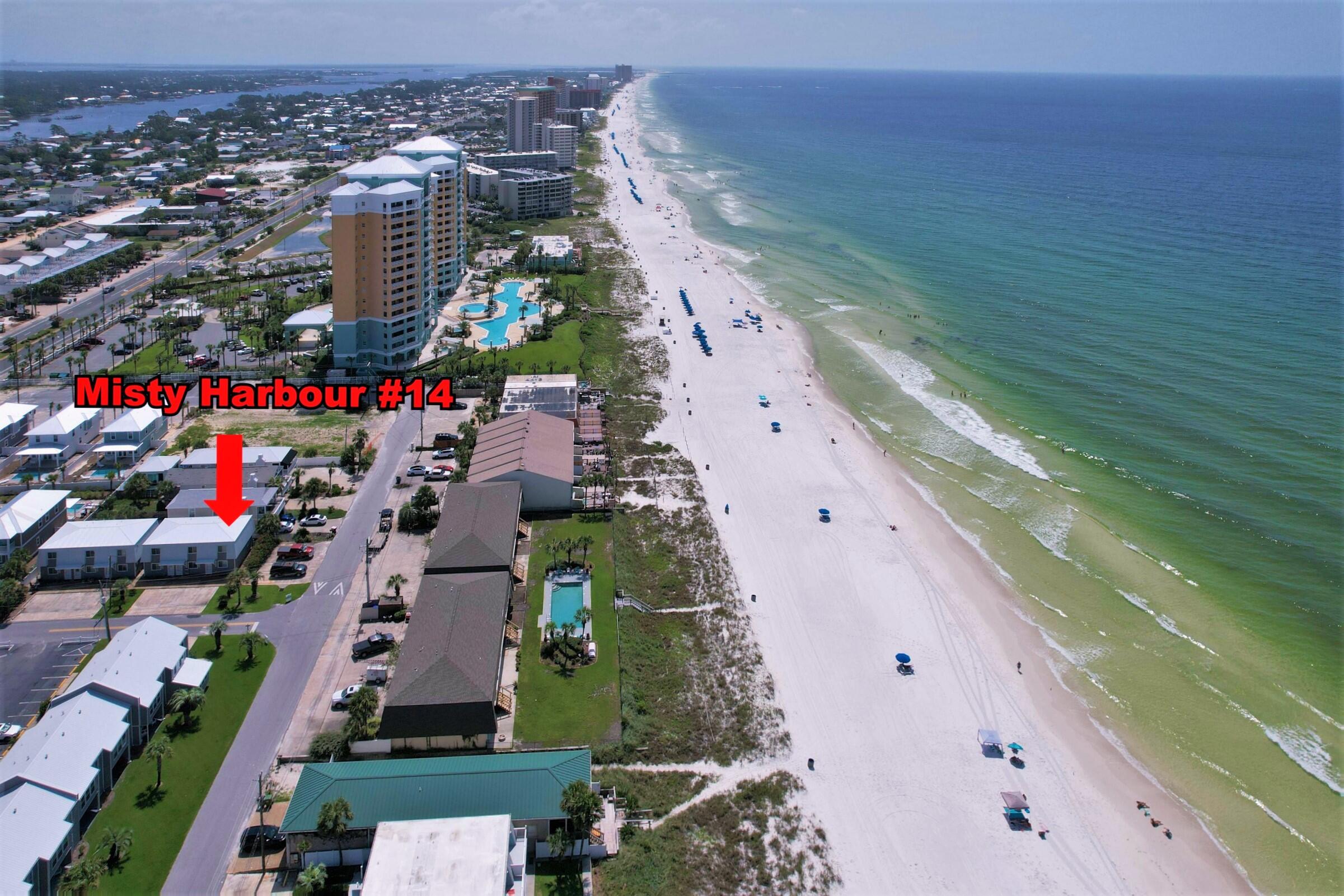 This Misty Harbour END unit condo is just steps from the beach! This is a 2BR/1.5BA townhome style condo that has been professionally decorated and staged and would make an excellent second home or short-term rental investment! Other units like this one average approx $31K+ in short-term rentals! This is an immaculate unit with the living area, kitchen and dining, and half-bath on the first floors while both bedrooms and the full bath are on the second level. There is ample parking, a community pool available and the gated/dedicated beach access is across the street! You're also walking distance to several restaurants and just short drive to shopping centers, St Andrews State Park and so much more. Move-in ready! All info is approx and must be verified by Buyers if important.