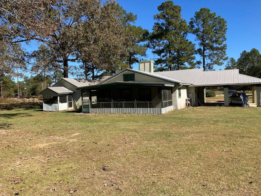 Approx. 2,482 sq. ft., 3/2 on 2.19 acres with a large shop in the back. Stucco exter., built to last in 1990.Large 2 car carport, Metal Roof. This home has a tiled entry, kitchen, and baths. 2 Bedrooms will need floor coverings.The huge closed-in rear porch over small piers with a fully finished ceiling and walls needs flooring. No remodeling done, all original., home needs updating!!Priced to sell!!