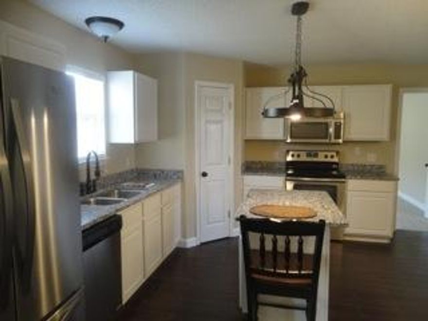 Don't miss out on this beautiful home. It's turn key ready and awaiting it's new owners. From the new metal roof (lower ins premiums) to new floors (tile and carpet), this 4 bedroom, 2 bath home has been updated throughout! In the kitchen you'll find beautiful granite countertops, new stainless steel Whirlpool appliances(Bottom-Freezer Refrigerator, Microwave, Smooth Top Range and Dishwasher), island and breakfast area. The centrally located living room features plant shelving and French doors with built-in blinds. The master bedroom will easily hold king sized furniture. Other new items include window blinds, all lighting & plumbing fixtures, door hardware, ceiling fans, fresh paint throughout, and much more!