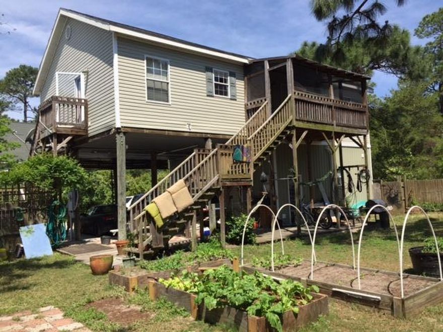 Dropped $30,000!! What an AMAZING OPPORTUNITY TO OWN IN SEA GROVE!! This is one of the remaining flips on Robert Ellis Rd. coming out of the recession.Home backs to the State Park, large yard, plenty of room for a pool -WALK TO to the BEACH!! Main living area on the 2nd floor with three large bedrooms and two baths. The open kitchen has plenty of space and counter area. Screened porch off the living room overlooks yard and park land. Fabulous permanent home or rental home. 25x28' STORAGE area (as defined per property appraiser site) has been finely finished with gourmet kitchen, huge island, loft and fireplace. Shown by appointment. Buyer to verify all information including all measurements.