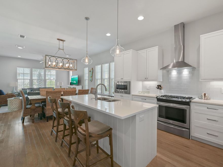 Tucked away in the gated community of Cypress Dunes on 30A, this spacious home comes with enviable onsite amenities. A brick-paved driveway leads to an attached garage for your golf cart, beach chairs and a covered entrance. Built in 2017 by renowned John Willis Homes, this well-appointed home has a metal roof, tankless water heater and separate air conditioning on each floor. It strays from the original plan with an additional fifth bedroom/bunk room to accommodate young guests. Hardwood flooring flows through the sitting area to a formal dining area beneath a contemporary chandelier. The open-concept kitchen revolves around a large island with bar seating for three. Crisp white cabinetry, quartz countertops and stainless appliances are complemented by a separate laundry room. There's also a master bedroom with an ensuite on this level. Head outdoors to the screened porch, which offers a quiet escape for socializing or sipping long cool drinks before dinner. An additional open deck is the perfect place to hang out for barbecues and alfresco dining. Wood-tread stairs lead up to three bedrooms (all with bathroom access) and a built-in bunk room for four. The home is ideal as a primary or second home and has a solid history of vacation rentals (six nights minimum). Look forward to fun-filled days on the tennis courts, working out in the fitness room or strolling along the boardwalk to nature ponds. The community infinity-edge pool overlooks the Gulf of Mexico and Topsail Hill State Park with its sail-like dunes and white sandy beach. Hiking, birdwatching and kayaking are available in the pine forest, lakes and wetlands nearby. Golfers are just minutes from four championship golf courses at Sandestin Golf and Beach Resort. Baytowne Wharf and Grand Boulevard provide a host of shopping and dining opportunities from Publix to Emeril's Coastal.