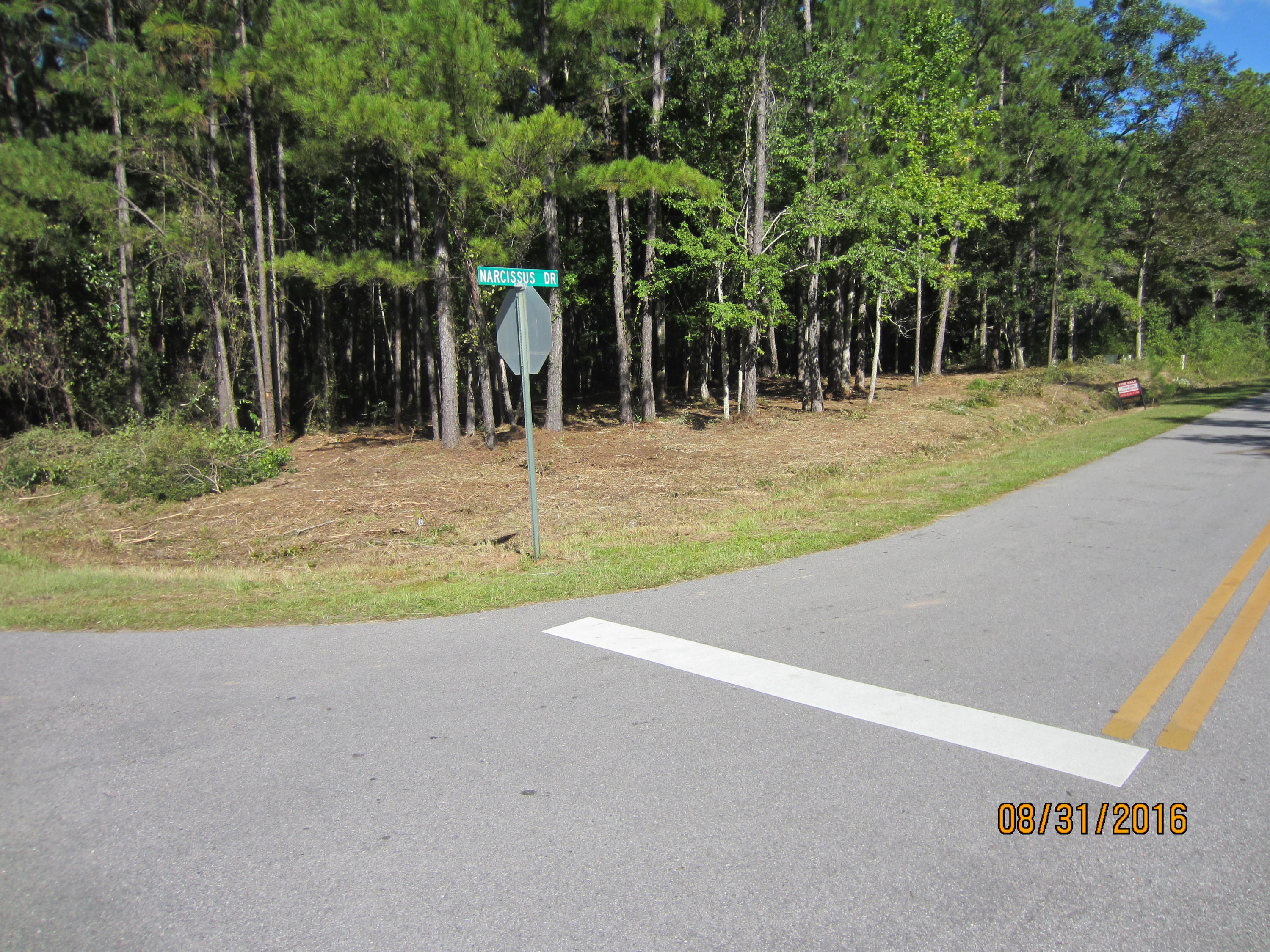 REDUCED PRICE...Nice corner lot with some mature trees in a very attractive subdivision. The lot is on the corner of Narcissus and Shoreline Drive and can be accessed from either Street. Lagrange Shores Subdivision has water access and paved streets. Water and Sewer are available. There is no build-out time requirement and no homeowners association; therefore, no monthly fees. The lot has been cleared of underbrush so it is easily walked. Great building lot or nice investment for the future.