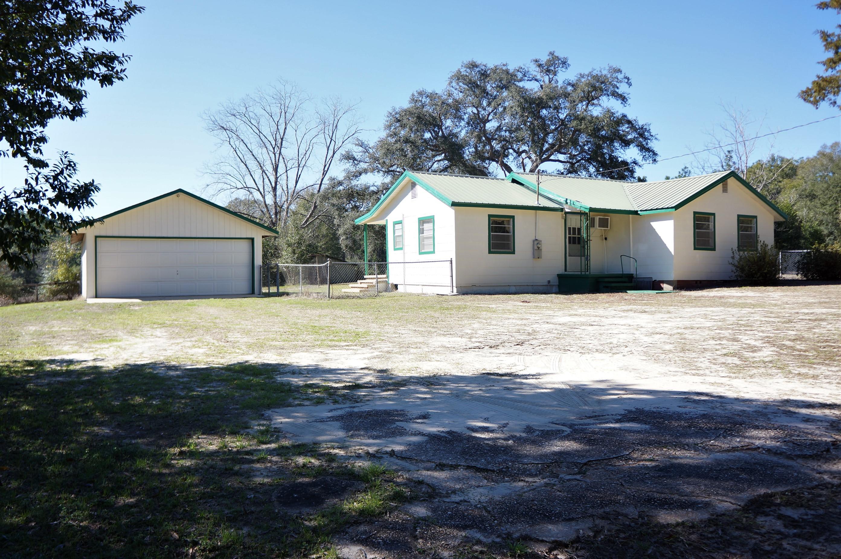 A Rare Find ...... ACREAGE CLOSE TO TOWN!! Quaint country farmhouse with a detached garage sits on 8.97 acres with 415 feet of paved road frontage. The home layout is split bedroom with a large dining room and a bright eat-in kitchen. Home has a metal roof, freshly painted and new carpet in the living room, dining room and one of the bedrooms. A new well was drilled in 2010. This property has a barn with water and electric and there is an additional equipment barn on the back acreage. With some updating this home will have great potential. PROPERTY IS BEING SOLD IN ''AS IS'' CONDITION.