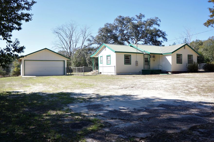 A Rare Find ...... ACREAGE CLOSE TO TOWN!! Quaint country farmhouse with a detached garage sits on 8.97 acres with 415 feet of paved road frontage. The home layout is split bedroom with a large dining room and a bright eat-in kitchen. Home has a metal roof, freshly painted and new carpet in the living room, dining room and one of the bedrooms. A new well was drilled in 2010. This property has a barn with water and electric and there is an additional equipment barn on the back acreage. With some updating this home will have great potential. PROPERTY IS BEING SOLD IN ''AS IS'' CONDITION.