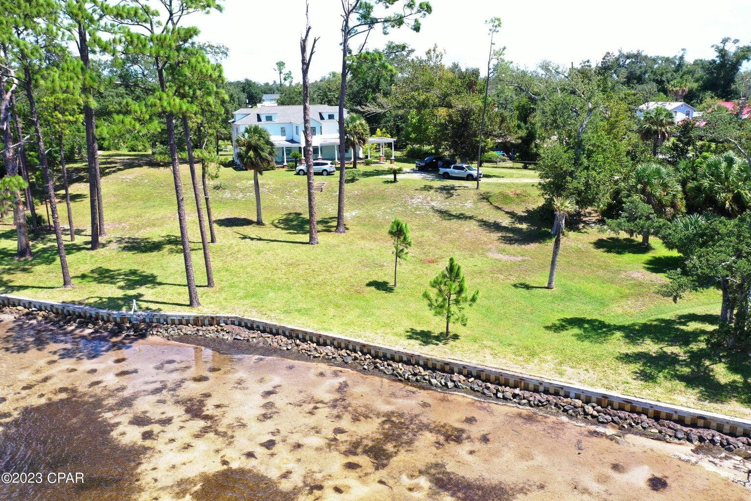 Amazing opportunity to own 255' of bayfront beauty in the heart of historic St. Andrews. Two homes occupy the lots, the larger home was built in 1895 and a brick home built in 1955. Use your imagination to place your dream home on this bay front estate or design multiple lots for development. Original plat had 5 lots for this property. The original structure may require too many upgrades to consider renovation. The second home is 1688 square feet built in 1955 has 3 bedrooms and 2 baths. The small home is in need of updating to blend in with the character of the neighborhood, enjoy a breath taking view of St. Andrews Bay from and elevation of +/-13 feet. Ships entering the bay all the way to the port, dolphins passing and brown pelicans diving for a meal! All at your back door view.