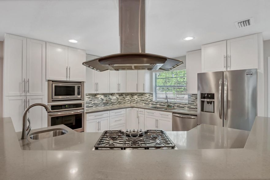 Outstanding, RENOVATED beauty on Bayshore! This home is sure to impress with its open floor plan, white shaker cabinetry, quartz counters, stainless appliances, cabinet lighting, and range hood! There are gorgeous engineered hardwood floors throughout, carpet in the bedrooms, no popcorn ceilings in this home! The split floor plan allows for 2 bedrooms up front, an office, towards the back of the home is the large master and 1 additional bedroom . The master bedroom has a private exit to the deck and backyard, and boasts a huge walk-in closet with custom built in shelving. The master bathroom is luxurious with a deep jetted tub and tiled walk in shower with glass enclosure and dual sinks. All three full bathrooms have been remodeled and finished with high end tile, vanities and toilets. There is PEX plumbing throughout, a new HVAC, newer stainless kitchen gas appliances, gas water heater, fenced-in yard, WORKSHOP, ample parking and circular drive, and you can park RV's, boats, etc as there is no HOA.  
The area boasts sidewalks, Lion's park is just 100 yards away with public fishing, picnic area, and boat launch. This is also where Niceville hosts their annual July 4th fireworks show!  
This home is centrally located and close to the beaches, shopping, dinning and doctors offices. You are 10 min from Eglin's East gate and roughly 25 min from Hurlburt. Should you be commuting to Crestview, Duke or the 7th SFG, you would be 20 min from those areas.  
This home has more amenities than many new homes, it is sure to impress and flexible to meet most families needs.