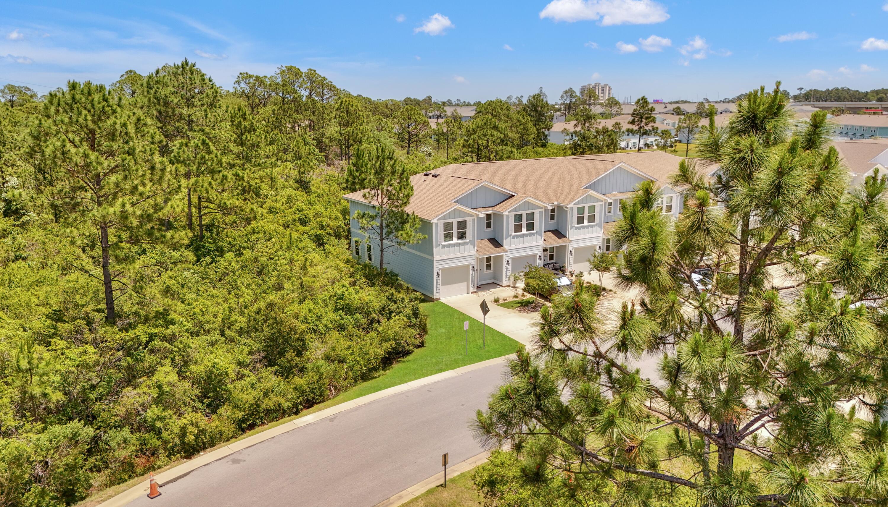 What if I told you there's a turnkey vacation home, 3 bedrooms, 2.5 baths, built in 2020, just a few minutes drive to the beach - and it's under $300K? Sounds too good to be true? Let me show you the real deal! Search on YouTube ''For Sale 7597 Shadow Lake Dr in Hathaway Townhomes'' for video tour. Welcome to your future Smart Home! This beautifully maintained end-unit townhome is like new inside and out, tastefully furnished, and fully rental-ready with strong projected GRI. Both short-term and long-term rentals are allowed, making it ideal as a primary home, vacation getaway, or income-producing investment. Surrounded by mature trees, this home offers stunning views from every room and is just 100 feet from the resort-style community pool. Inside, enjoy an open layout with SS appliances granite countertops in the kitchen and bathrooms, and stylish furnishings and accessories throughout. Additional features include a one-car garage plus three driveway spaces, and you're only a 7-minute drive to the beach, restaurants, nightlife, grocery stores, Gulf Coast College, Sports Complex, and more. VA and FHA approved! The smart home package includes an ADT video doorbell camera and a touch panel for thermostat and optional security system control. The HOA fee includes exterior insurance, landscaping, irrigation, pool access, and trash pickup with the majority of the fee covering exterior insurance, offering significant savings. All information is believed to be accurate; buyer to verify if important.