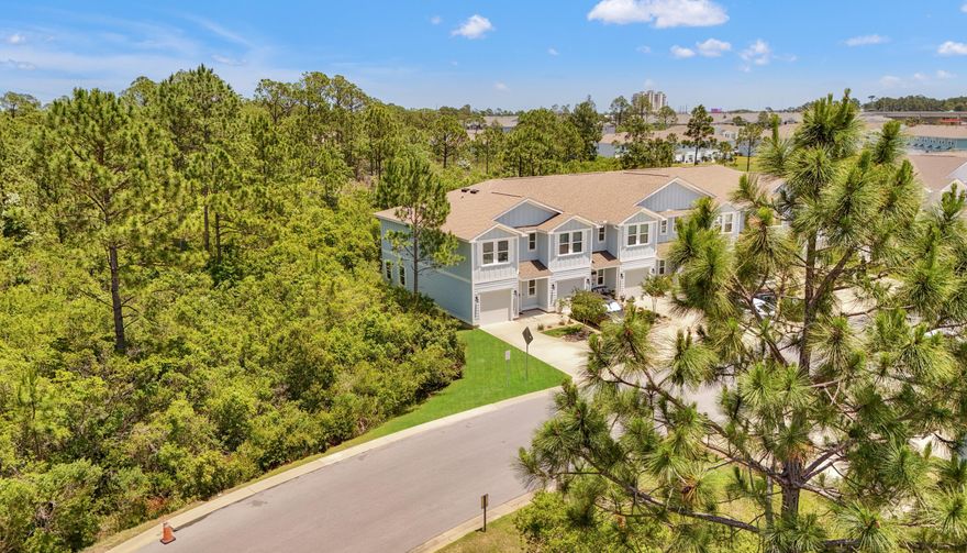 What if I told you there's a turnkey vacation home, 3 bedrooms, 2.5 baths, built in 2020, just a few minutes drive to the beach - and it's under $300K? Sounds too good to be true? Let me show you the real deal! Search on YouTube ''For Sale 7597 Shadow Lake Dr in Hathaway Townhomes'' for video tour. Welcome to your future Smart Home! This beautifully maintained end-unit townhome is like new inside and out, tastefully furnished, and fully rental-ready with strong projected GRI. Both short-term and long-term rentals are allowed, making it ideal as a primary home, vacation getaway, or income-producing investment. Surrounded by mature trees, this home offers stunning views from every room and is just 100 feet from the resort-style community pool. Inside, enjoy an open layout with SS appliances granite countertops in the kitchen and bathrooms, and stylish furnishings and accessories throughout. Additional features include a one-car garage plus three driveway spaces, and you're only a 7-minute drive to the beach, restaurants, nightlife, grocery stores, Gulf Coast College, Sports Complex, and more. VA and FHA approved! The smart home package includes an ADT video doorbell camera and a touch panel for thermostat and optional security system control. The HOA fee includes exterior insurance, landscaping, irrigation, pool access, and trash pickup with the majority of the fee covering exterior insurance, offering significant savings. All information is believed to be accurate; buyer to verify if important.