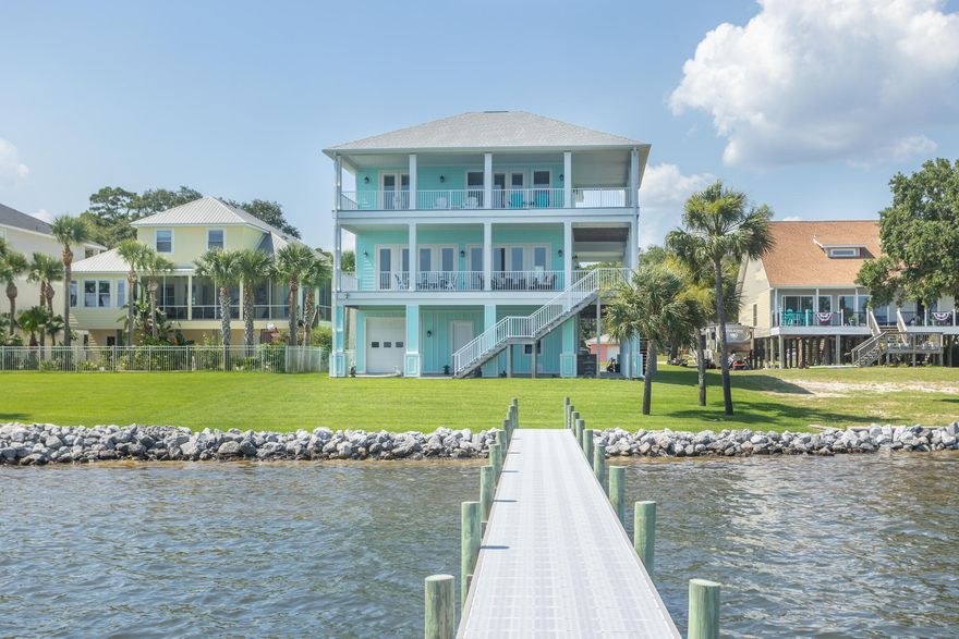 Stunning panoramic views of the Santa Rosa Sound from this bright & sunny custom built WATERFRONT home. The main living area & kitchen offers a wall of high quality impact glass doors so there are beautiful  views of the water from the entire space. The living room has built-in entertainment center. The open kitchen features custom white cabinets that go all the way to the ceiling, an oversized walk-in pantry; Kitchenaide appliances include: stainless oven, microwave, dishwasher, 36'' gas range; and a Samsung 4 door stainless refrigerator; large island with storage, range hood vented to the exterior; under cabinet lighting; recessed lights, and pendant lights. Countertops are ''Fantasy Brown'' dolomite;  The master bedroom has gorgeous views of the sound and entry to the rear.. (more).