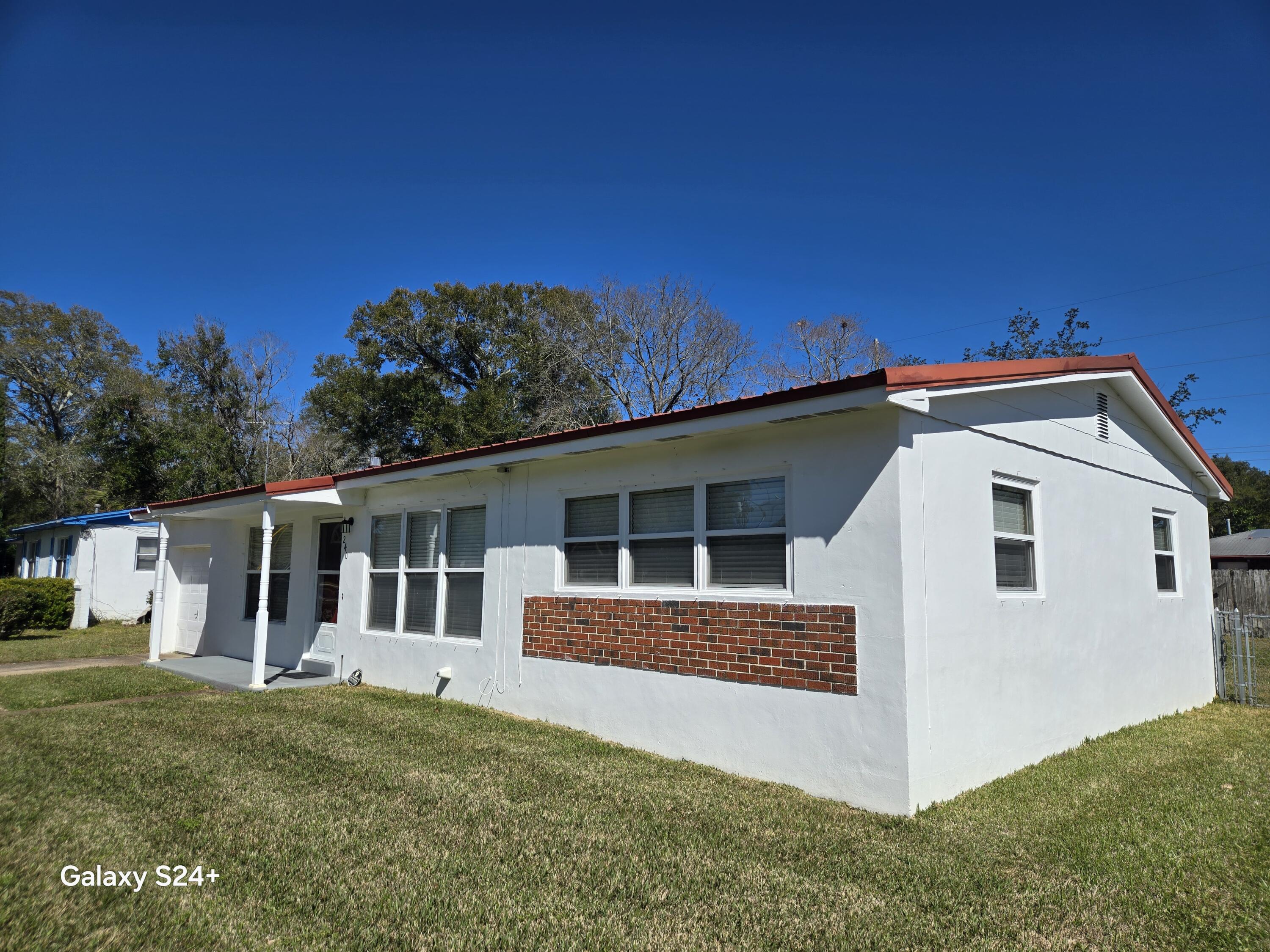 This beautifully renovated Old Florida cottage boasts a durable concrete block construction topped with a modern metal roof. Enjoy peace of mind with energy-efficient insulated windows throughout, along with the upgrade from aluminum to copper wiring, ensuring safety and reliability. The property has been meticulously maintained, with weekly lawn care ensuring a lush outdoor space for relaxation and entertainment. Take advantage of the assumable water and sewer line insurance for added convenience.Inside, you'll find a stunningly renovated kitchen equipped with modern appliances, perfect for culinary enthusiasts. The newer air conditioning system and handler are inspected and serviced annually, providing a comfortable atmosphere year-round Water filter system is in place as well as pre-cut plywood and clips to shutter windows for storms. This charming home offers both character and community. Don't miss your chance to own this delightful property schedule a showing today!