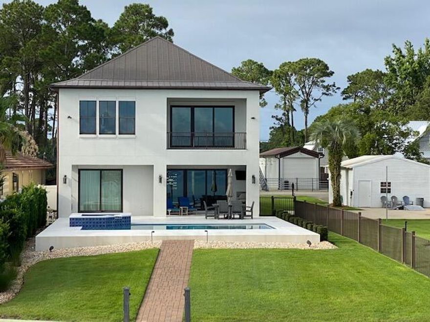 Very nice custom bayfront home built by highly respected DKM Builders. Beautiful unobstructed bay views on private dead end street and just seconds from everything. Master on the main. All 4 bedrooms are large enough to accommodate king size beds. Upstairs living room can easily be converted to a 5th bedroom. Impact doors and windows through out.  New A/C units inside & outside. Home has tons of extras and is a must see.Lot 4 with detached garage, basketball court and bonfire pit is NOT included in sale and will be separated at closing.  Lot may be purchased for an additional $800,000 with and ONLY with the purchase of home.  Please allow 24 hours to schedule showings.  All dimensions to be verified