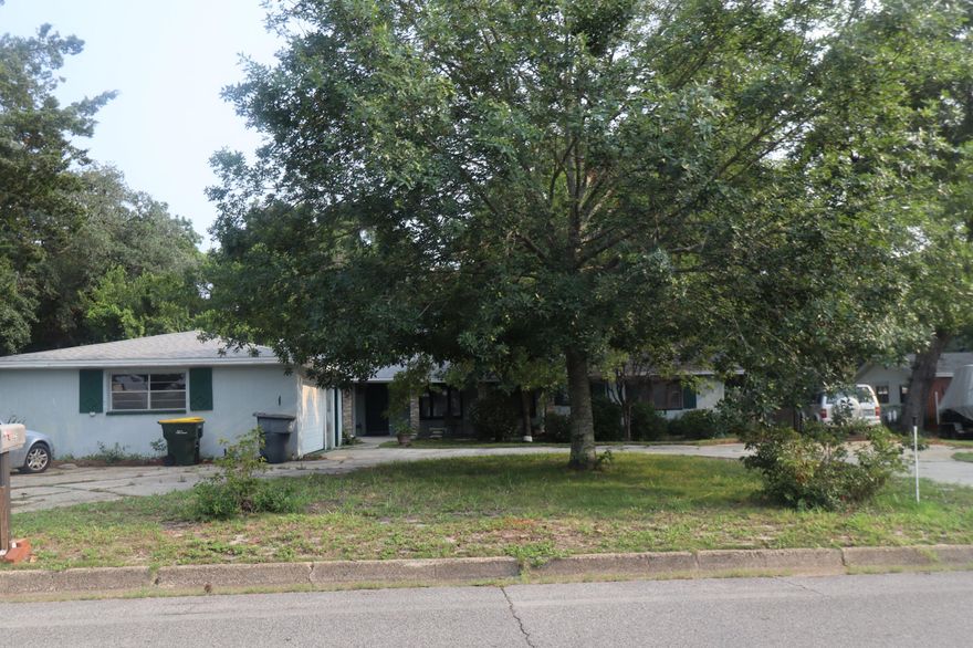 PLENTY OF ROOM TO ROAM on a large lot on historic ''Brooks Street'' downtown Fort Walton Beach. Intercoastal Waterway is just across the street. You will be greeted by a convenient circular driveway, lots of landscaping and a canopy of mature trees. Spacious living room boasts a fireplace and two picture windows. Dining room has laminate flooring and a built-in desk. The cozy family room steps down to a fireplace, built-in bar. French doors lead out to a large 24ft x17ft covered patio. Kitchen opens to the dining area and features custom built cabinets, expansive corian countertops, breakfast bar and acess to the large laundry/utility room, workshop and oversized garage. Three bedrooms on the main floor with two full baths. Upstairs contains three additional bedrooms and a full bath making this the perfect set-up for extended family. The backyard has plenty of room for a pool and the workshop in the back would make a great pool house. Convienent location within minutes of the public boat launch, easy access to Okaloosa Island & Destin, and an easy walk or golf cart ride to local restaurants, shops, & the festivals. Close proximity to all military bases. Don't miss this fantastic opportunity! Ideal for both boaters and beach lovers take a look today!