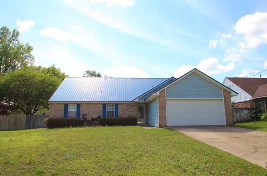 Excellent location just a little north of I-10. This home has four bedrooms and three full baths. All new interior paint and brand new carpeting. Nice shady privacy fenced backyard. Two car garage. Wood burning stone fireplace in the living room. Roomy utility room. Very large kitchen with all appliances and a sunny spacious dining area. Master bedroom and two additional bedrooms are downstairs and upstairs is a very large bedroom and bath. Perfect for guests, mother-in-law suite or teens. Quiet neighborhood and you can reach Walmart without even getting on the highway! Seller will provide Old Republic One Year Home Warranty.