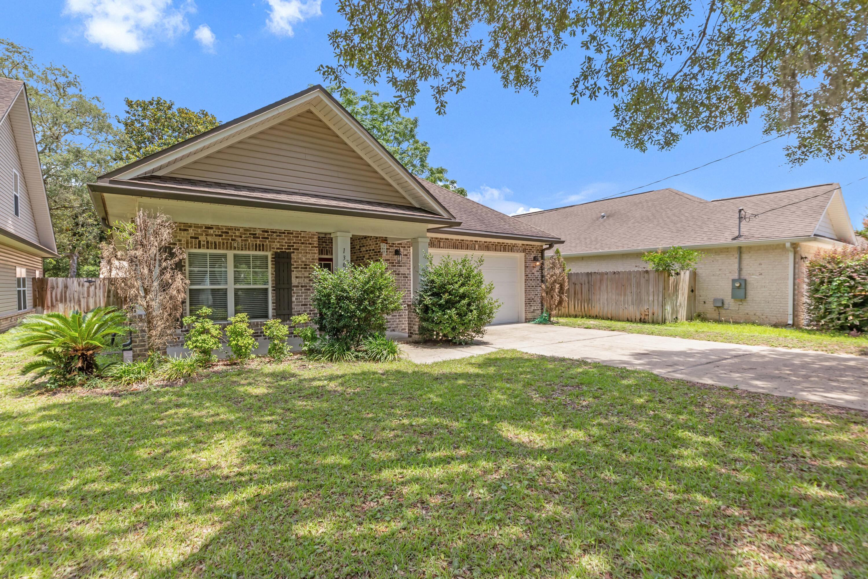 Tucked away on a quiet street in the heart of Niceville, this charming 3-bedroom, 2-bathroom home offers comfort, style, and smart design all on a single level. Whether you're just starting out, growing a family, or looking to downsize without compromise, this well-maintained residence has it all.Step up to a welcoming covered front porch, where classic brick accents and elegant columns set the tone for what's inside. Enter through the foyer and notice the durable, hand-scraped laminate wood flooring -- attractive and built to last.To the left, a hallway leads to two spacious guest bedrooms, each featuring Mohawk brand carpet, 9-foot ceilings, and stylish lighting. Between them, a fully equipped hall bath boasts a granite-topped vanity and a tub/shower combo -- ideal for guests or kids. Back through the foyer, the heart of the home unfolds with an open-concept kitchen, dining, and living area perfect for both everyday living and entertaining. The kitchen impresses with rich wood-stained cabinetry with crown molding, granite countertops, and stainless steel appliances, including a range, microwave, and dishwasher. A central island with undermount sink and pendant lighting creates a warm gathering space for meals or casual chats.
From the kitchen, enjoy a panoramic view of the living room and backyard through large, double-pane windows. A cozy dining area sits just to the side with easy access to the covered back patio, ideal for summer grilling or morning coffee.
Off the kitchen, a small hallway leads to a laundry room, storage closet, and access to the attached two-car garage. On the opposite side of the home, privacy awaits in the owner's suite. This peaceful retreat features a walk-in closet, a second standard closet, and an en-suite bath with raised-height double vanity, granite countertops, a soaking garden tub, and a separate walk-in shower.
Additional highlights include:
Completely fenced backyard perfect for kids or pets
Irrigation system in place for easy lawn care
Manabloc plumbing system for efficient water use
R-38 blown insulation and energy-efficient appliances for lower utility costs
Located just minutes from schools, parks, shopping, and dining this home truly checks every box.
Schedule your private showing today homes in this desirable Niceville location don't last long!