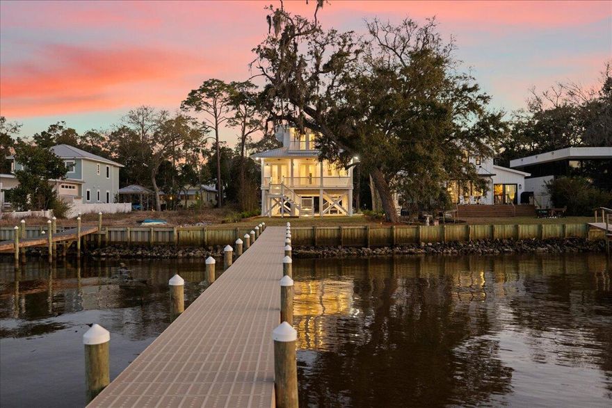 Welcome to 115 Native Tree--where classic Florida cottage charm meets modern sophistication. Perched on pilings in a nod to Old Florida's timeless design, this home is elevated to capture breathtaking bay views while offering future possibilities for its new owners. Whether you envision a garage, additional parking, or racks for your surfboards and paddleboards, the raised foundation provides flexibility for your coastal lifestyle or just enjoy the stunning bay views.  Inside, the warmth of white oak flooring flows throughout, leading you to an open-concept living space where the custom designer kitchen with Thor appliances overlooks the bay and seamlessly connects to an expansive rear porch--perfect for taking in those iconic waterfront sunsets.With four bedrooms and four baths this home exudes effortless style, infused with a subtle Australian-inspired flair. The custom all-oak staircase is a true masterpiece, anchoring the home's impeccable craftsmanship. Every bathroom features designer tile and quartz countertops, creating a luxurious yet inviting atmosphere.

Every detail has been thoughtfully curated, from the professionally landscaped grounds to the lighted steps and irrigation system. 115 Native Tree is more than a home; it's a work of art designed for those who appreciate classic beauty with modern comfort.

All information is deemed reliable and provided for informational purposes; buyers are encouraged to independently verify all details.

