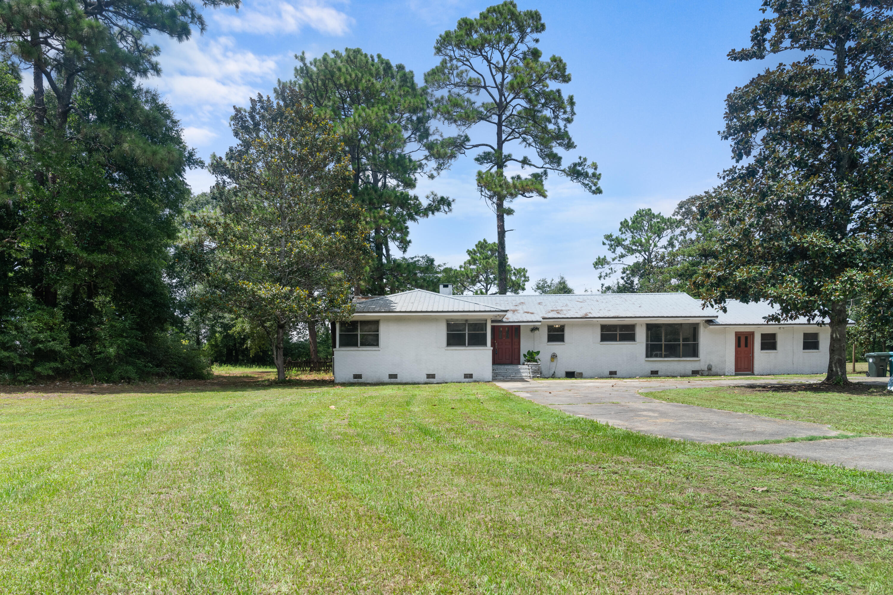 This hidden home, on 2 acres of lakefront land, offers a rare opportunity to finish a dream renovation. With its own private dock on Lake Stanley, a nearby public park, and direct access to Hwy 90 and I-10, this location combines quiet lakeside living with convenience to the Emerald Coast. The 8-car driveway is perfect for hosting or storying toys. Updates already done include- brand new appliances installed in the open-concept kitchen, and fresh LVP flooring runs through the main living areas. The home also features an added Florida room, walk-in pantry, laundry room addition, and a bonus room that would make the perfect mother-in-law suite (has its own entrance)! The roof is just 5 years old. This home provides a canvas for buyers to finish the perfect lakefront retreat!