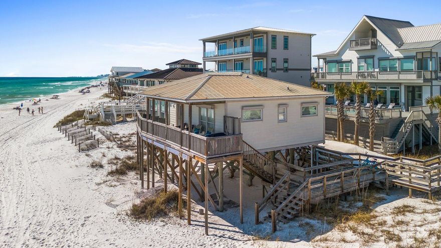 Set on a prime Gulf-front lot along the West End of 30A, this classic beach cottage offers a rare combination of privacy, character, and uninterrupted views of the emerald Gulf and sugar-white sands. Tucked away from the main thoroughfare but still close to top-tier dining, shopping, and outdoor destinations, the property blends timeless Old Florida charm with the best of coastal living.Designed with simplicity and comfort in mind, the cottage features two well-sized bedrooms -- each with its own ensuite bath -- and an open-concept main living area that maximizes both space and views. Natural light floods the interior through large windows, creating a relaxed, airy atmosphere ideal for a true beach retreat. Whether cooking in the efficient, well-equipped kitchen or relaxing in the living space, you're never far from the Gulf's presence.

Outside, a covered porch offers a quiet place to enjoy morning coffee or evening breezes, while a dune-front deck brings you even closer to the shoreline. With private beach access just steps from the door, days here move at the pace of the tideeasy, calm, and grounded in nature.

Offered fully furnished and including a complete set of architectural plans for a future build, this property is ready for immediate enjoyment or long-term vision. Whether you're looking for a peaceful getaway, a strong investment property, or the perfect site to build a custom Gulf-front home, this is a rare opportunity to own a piece of 30A with both charm and potential.