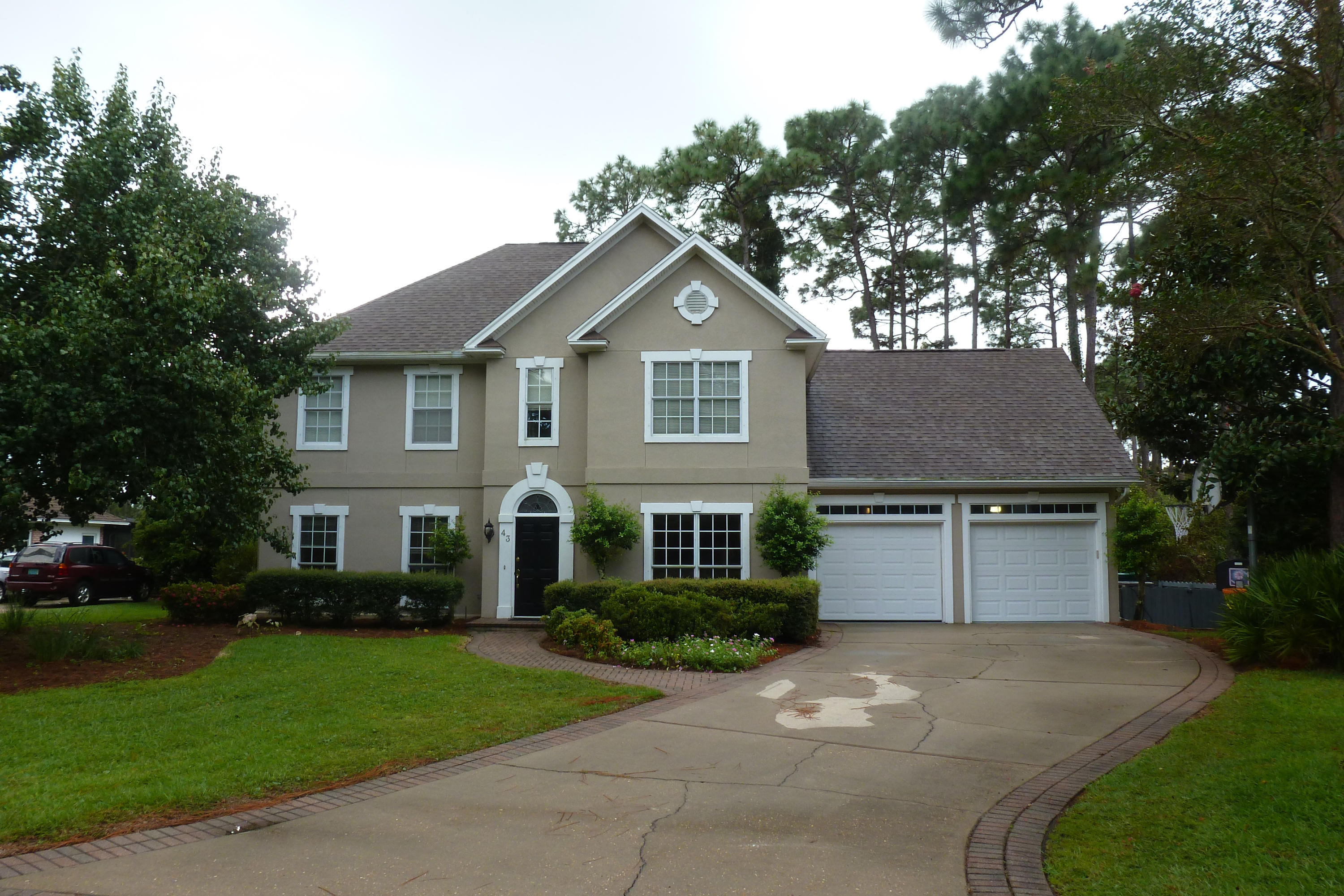 Don't miss this one! Curb appeal galore with this 2 story, 4 bedroom custom stucco home in the sought after gated community of Southwind. This is truly an amazing home! Wonderful floor plan with travertine tile floors, heavy crown molding, granite counter tops, and a master bath that is to die for! Light and bright eat-in kitchen overlooks the lush landscaping of the backyard and the #1 tee box on the Marsh Golf Course at Bluewater Bay. There are two large living areas and a formal dining room as well. All rooms have wonderful light and are oversized. There are 4 spacious bedrooms and the hall bathroom upstairs has a double vanity and travertine floors. The 1/2 bath has granite countertops. New roof in 2006 and freshly painted walls in 2013. This home is move in ready!