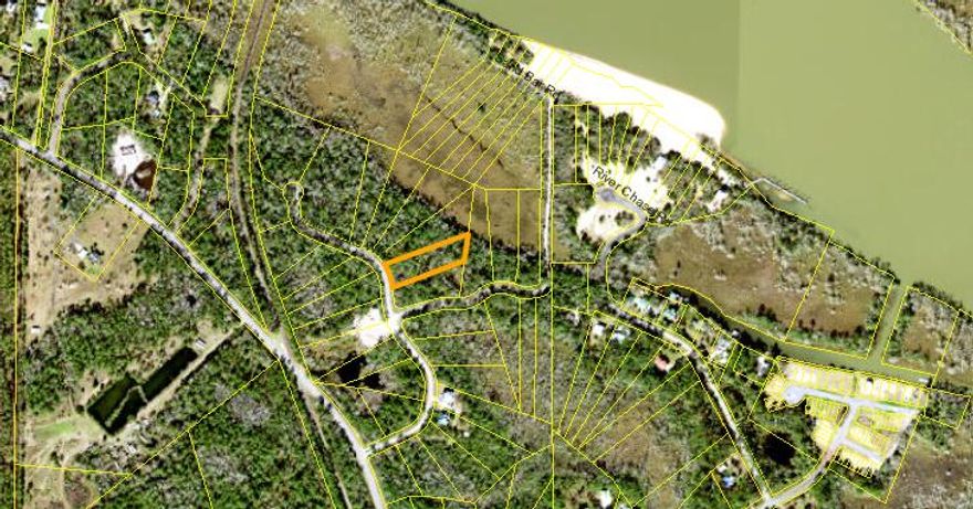 This one-acre wooded corner lot is nestled within the 90 acre River's Edge Subdivision. This is a private, gated community with paved roads and underground utilities in a serene and beautiful environment. There is a 1.4 acre common area of sand dune/beach along the Apalachicola River. This subdivision is located off of 12th street with easy access to the shopping and dinning of downtown Apalachicola. With multiple boating access points less than 10 minutes away, one is never far from some of the best fresh and saltwater fishing in Florida! Thirty minutes or less, to the world renowned, white sugar sand beaches of St George Island and Cape San Blas. Live the Forgotten Coast dream!
