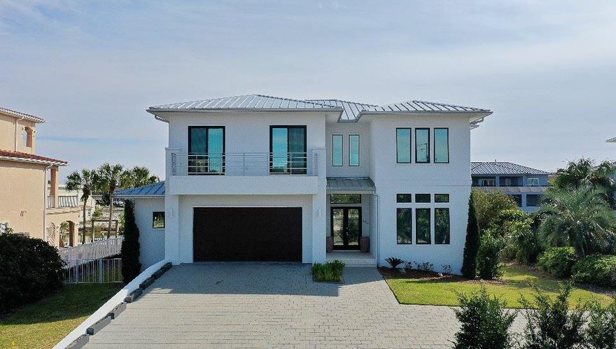 Lounge by the sparkling pool and enjoy your favorite beverage or watch the fish playing in the canal. Conveniently located near the MAJOR water attractions in the area, you are just a short boat ride to the Gulf, Harbor, and Crab Island. Featuring over 5086 sf of living space, and an additional 1000 sf of porches, this amazing home has 5 br, 5.5 Ba, and a living rooms upstairs and downstairs. As you walk into the home, the open floor plan and attention to detail are immediately evident. The towering ceilings and commercial grade kitchen including; quartz countertops, Sub Zero Appliances, Wolf Double Ovens, Wolf Gas Stove, Wine Cooler, Hidden Pantry, and Ice Maker, are impressive. With almost 90 foot of canal boat dockages, there is plenty of room for all of your boats!