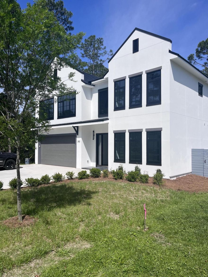 In the heart of Mack Bayou between Sandestin and Hwy 30A, you'll find a rare opportunity to live in modern luxury surrounded by wooded tranquility. This new construction home rarity is less than 2 miles from the shops, dining and entertainment of Sandestin, around the corner from Sacred Heart Medical and just minutes from the white sandy beaches of Hwy 30A. This home boasts 10' ceilings on the lower and upper levels, master suites on both floors with a total of 4 large bedrooms and 3.5 bathrooms with loft upstairs open to below. The spacious two story great room is perfect for entertaining and access to the private back yard through the covered patio. Mack Bayou Estates is an established neighborhood in Santa Rosa Beach with no operating HOA.  This retreat will have bragging rights as it is adorned is smooth white conventional stucco and sleek, black modern windows and doors. A two-car garage with ample space was thoughtfully designed for the full-time resident or second home resident in mind. The back yard is oversized and is the perfect place to create your own oasis with a lanai or patio for the best entertaining on the block. This residence features city water and sewer as well as irrigation. High-end appliance package and beautiful tile and cabinetry, this new construction home is a gem.