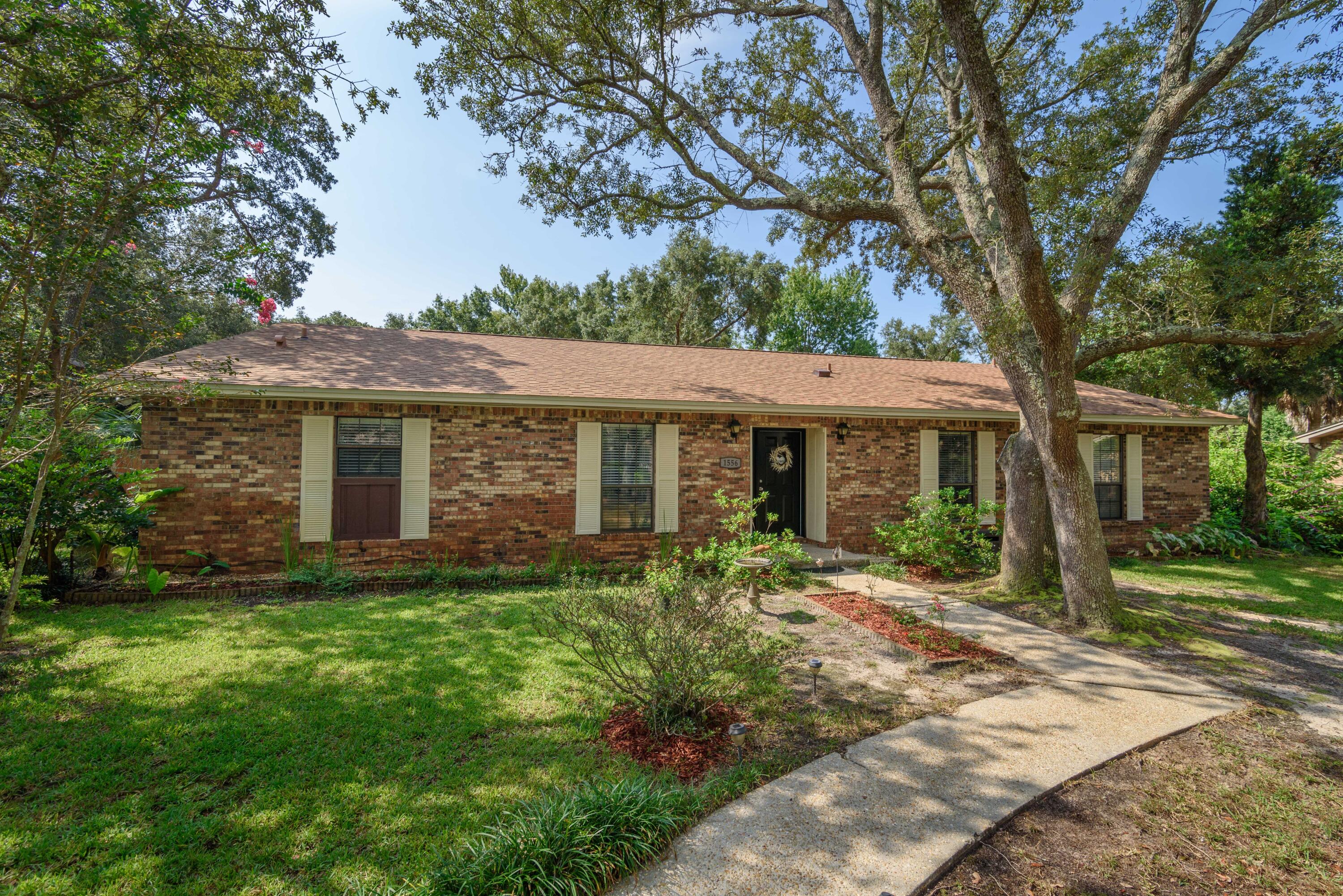 Nestled on a cul-de-sac on the community of Bay Woods, this home offers a swimming pool (NEW pool liner 2020) and a completely remodeled kitchen with 2 yard storage buildings. You'll also enjoy the screen enclosed patio and the mature landscaping with a plethora of beautiful Oak trees. The expansive back yard is fenced and has a charming treehouse for kids and an open deck great for entertaining. The remodeled kitchen comes equipped with modern cabinetry, glass mosaic tile backsplash, a long buffet style serving area that also provides additional cabinet storage, built-in desk, pantry and breakfast nook encompassed with a bay window providing ample natural light. You'll love 2 separate living spaces including the spacious living room and den which has a updated mantle and wood burning fire