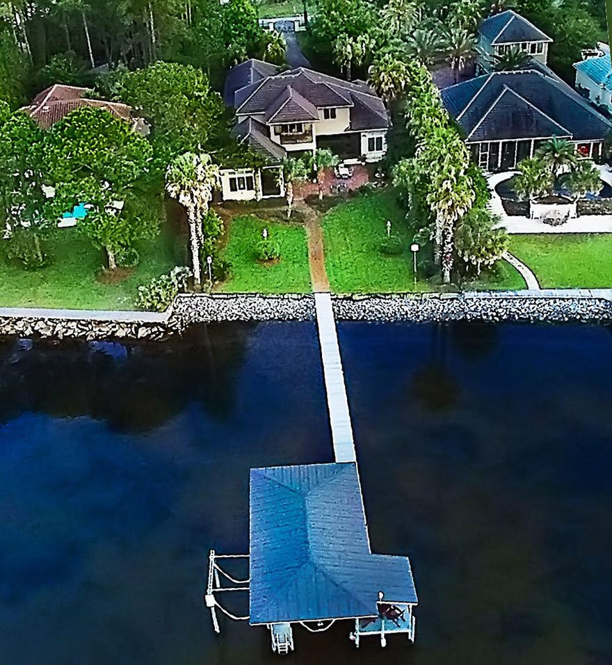 Authentic New Orleans gas lights greet you as you approach the 8 ft double doors at the entrance of this elegant estate. There are bay views from the living and dining rooms, bar, kitchen and eating areas, office, den, rec room and master suite. The custom designer kitchen is beautifully appointed and has top of the line commercial appliances and a huge island for easy entertaining. There are 3 bedrooms and a possible 4th and 4 1/2 baths. The screened lanai features a TV above the fireplace and a built-in grill. Other features of this home are a boat dock, 1/2 bath in the garage, a room above the garage, huge amount of storage space and a generator.This home was built by Jason Romair.