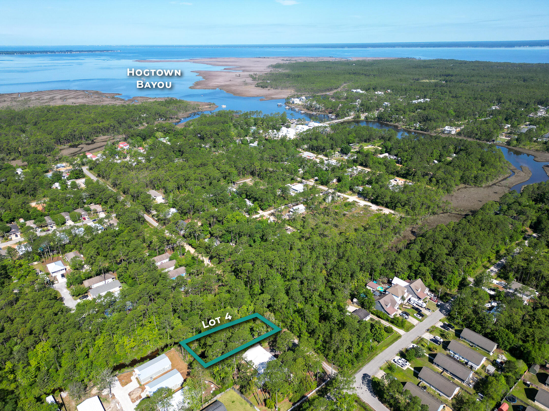 Located on a small bayou that flows from the Choctawhatchee Bay, and the lot is buildable. The property line on the east runs along the privacy fence and the Bayou on the West side. NO HOA, NO BUILDING RESTRICTIONS, NO BUILD OUT TIME. Tap fees Due. The wetlands run along the bayou (marked by flags) and the lot is buildable with the 25 foot wetlands setback. (See Survey) There is a pole barn located on the property being sold as is. Buyer to verify all that is important to them.