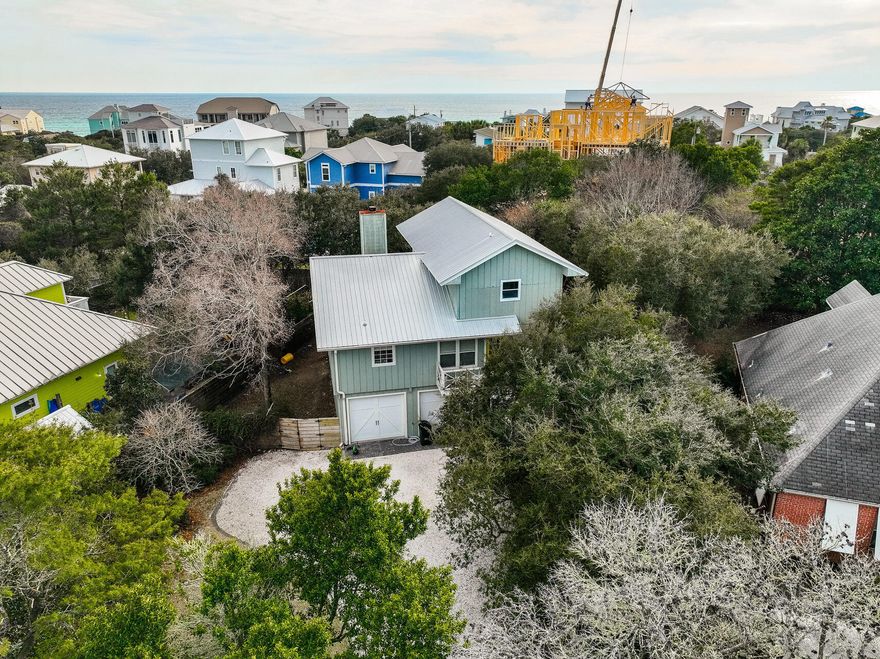 Professional Photos to COME! Situated on a spacious quarter-acre lot in the desirable Dune Allen Beach community, this 3 bedroom, 3 bathroom home is filled with charm and is within only a 3 minute walk to the closest public beach access, as well as delicious dining at Stinky's Fish Camp. The main home is situated on the 2nd and 3rd levels and offers a deep porch off of the open concept kitchen and living room. The expansive back porch, positioned off of the 2nd level, spans the width of the home & overlooks a beautiful backyard, perfect for relaxing with excellent privacy provided by the mature landscaping and trees allowing for shade and seclusion. The guest suite and 2nd bathroom are also on the second level while the primary suite awaits on the third level.  On the ground level, adjacent to the 2 car garage, you will find a lockout apartment with everything one needs including a kitchenette and living area as well as a full bedroom and bathroom. Fantastic opportunity for an AirBNB or a single level mother-in-law suite! This non HOA property sits in an X flood zone & offers an incredible, income-producing opportunity, as-is, yet also provides the chance to utilize the spacious lot and create your own dream home built to your desired specifications, if you choose to do so. Located only 2 streets away from the beach and in an outstanding location, this property is not one to be missed!