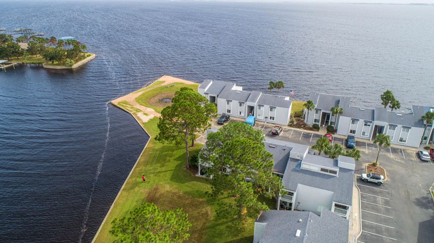 No short term rentals. Your charming 2 bedroom / 2 bath waterfront condo is the perfect retreat. This gated complex on Lake Clyde and the bay in Shalimar greets you with tall pines and palms. Tile floors link the entryway and open floor plan of the living and dining rooms. A large sliding window provides natural light from across the dining area.  To the left, the living room has sliding door access to a private balcony where you can enjoy the peaceful bay breeze as you relax in the evening.  From your backyard, enjoy sunsets over Lake Clyde and views of the Choctawhatchee Bay, and even Crab Island and The Emerald Grande off in the distance.