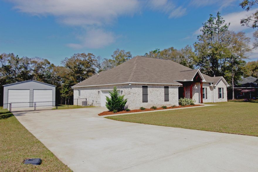 SELLER OFFERING $10,000 Concession to BUYER'S CLOSING COSTS with Acceptable Offer! Nestled on a sprawling, fully cleared acre, this exceptional four-year-old home offers a sanctuary of space and modern comfort. A concrete driveway guides you to both the attached two-car garage and the impressive 40ft x 30ft workshop garage, complete with three roll-up doors and a private entry, perfect for hobbies or storage. Inside, nine-foot ceilings, with eleven-foot ceilings in the laundry room and front bedroom create an airy and grand atmosphere. The open concept living and dining areas, accentuated by recess lighting and crown molding, flow seamlessly into the gourmet kitchen, which boasts custom white cabinets, quartz countertops, and a center island boasting a ceramic farm sink. The custom range hood features a wood beam casing with ship lap. The electric center Fireplace is surrounded by brick and center Fireplace is surrounded by brick and shiplap to enhance the concept design of the home. Plenty of windows bring in natural lightning to all the rooms. Three extra-large guest bedrooms offer ample closet space, while the master suite provides a luxurious retreat large enough to have a quite sitting area. The Master Bath Suite boast dual vanities, a soaker tub, and a walk-through closet leading to the spacious laundry room and mud room just off the kitchen. Thoughtful details abound, including a full hall bath with a private commode, a half bath off the mudroom, and a covered patio with TV hookups. Premium finishes, such as 12-inch wide LVP flooring, 5-inch farmhouse baseboards, and black steel hardware, elevate the home's elegance. The entire back yard is fenced in and is equipped with a sprinkler system. Ensuring a lush, manicured lawn surrounds this remarkable property.