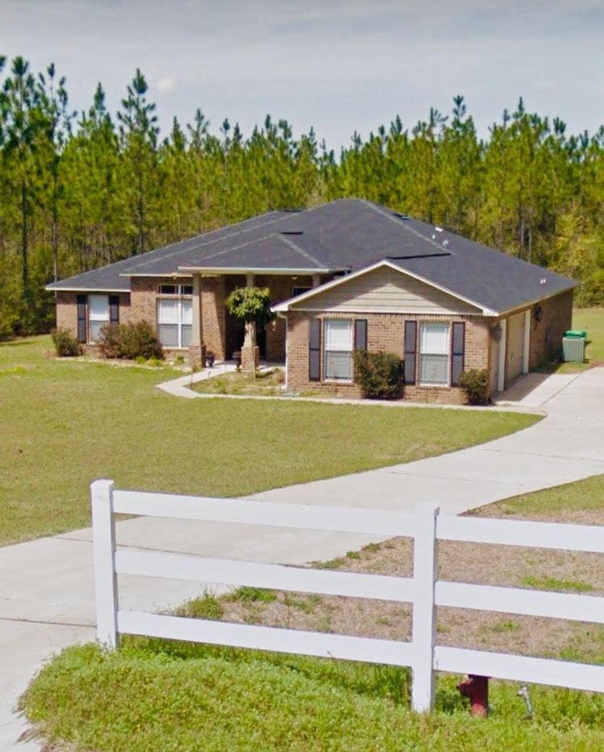 5 Bed/3 Bath all-brick home rests on a 1.82-acre wooded lot of lush pine and oak trees within the new and exclusive Yellow River Plantation. This home of 3,650 sq. ft. reflects the country spirit and the elegant environment of the subdivision.The entryway to this impressive brick home, which features a 3-car, side-entry garage, is lined with trees and white picket fencing for a private and exquisite feeling. Upon entering, you will immediately sense the spacious design; from the 10' ceilings to the large, open rooms, and expert layout. The foyer leads to a den/formal dining room on the right upon entering, then opens up to a spacious living room. The living room then connects to a gorgeous sunroom overlooking the lovely Florida foliage in the backyard. Also looking toward, the sunroom