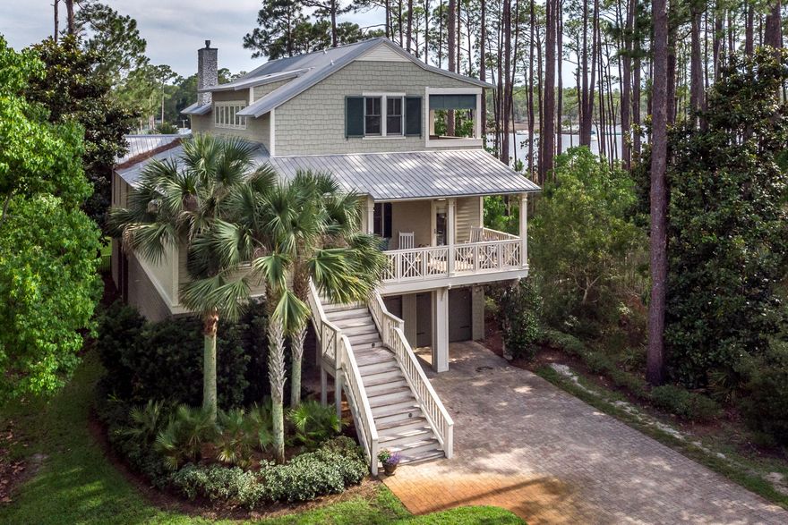 Within the private and serene WATERFRONT community of Cessna Landing lies your escape to tranquility and boater's paradise. Prominent build quality, direct water frontage and captivating views beckon the most discerning. Just minutes to the beaches of 30A and situated amongst mature pines is a serenely placed 5BR/4.5BA, plus flex room, luxury home featuring nearly 3,300 sq ft of living space, dock with boat/jet ski lift and a 2 lane garage suitable for 4 vehicles. The spacious open concept, ideal for entertaining and family gatherings, is centered around an oyster shell clustered gas fireplace and 14 ft natural stone kitchen island. A chef's kitchen includes a Thermador refrigerator, 48'' gas range with stainless vent hood and prep alcove with sink and second dishwasher, warming drawer, ice maker and wine cooler. Indoor living extends outdoor to a peaceful screened in living area with complete summer kitchen including a gourmet grill and vent hood, pot filler and gas burner.  Exquisite hard wood oak flooring spans the entirety of the first level including the master suite featuring a large seating area, expansive bathroom with 6 head spa like shower and a generous 13x11 walk in closet. The second level contains 3 bedrooms and 2 baths with a private balcony overlooking the water, along with ample storage.  The fully enclosed garage is suitable to store boats/jet skis/boats/trailers and is currently sectioned to include a work station.  You will appreciate fine features such as interior/exterior surround sound, 10 and 12ft ceilings, 11" trim package, 8ft interior solid core wood doors, infrared patio heaters and more.